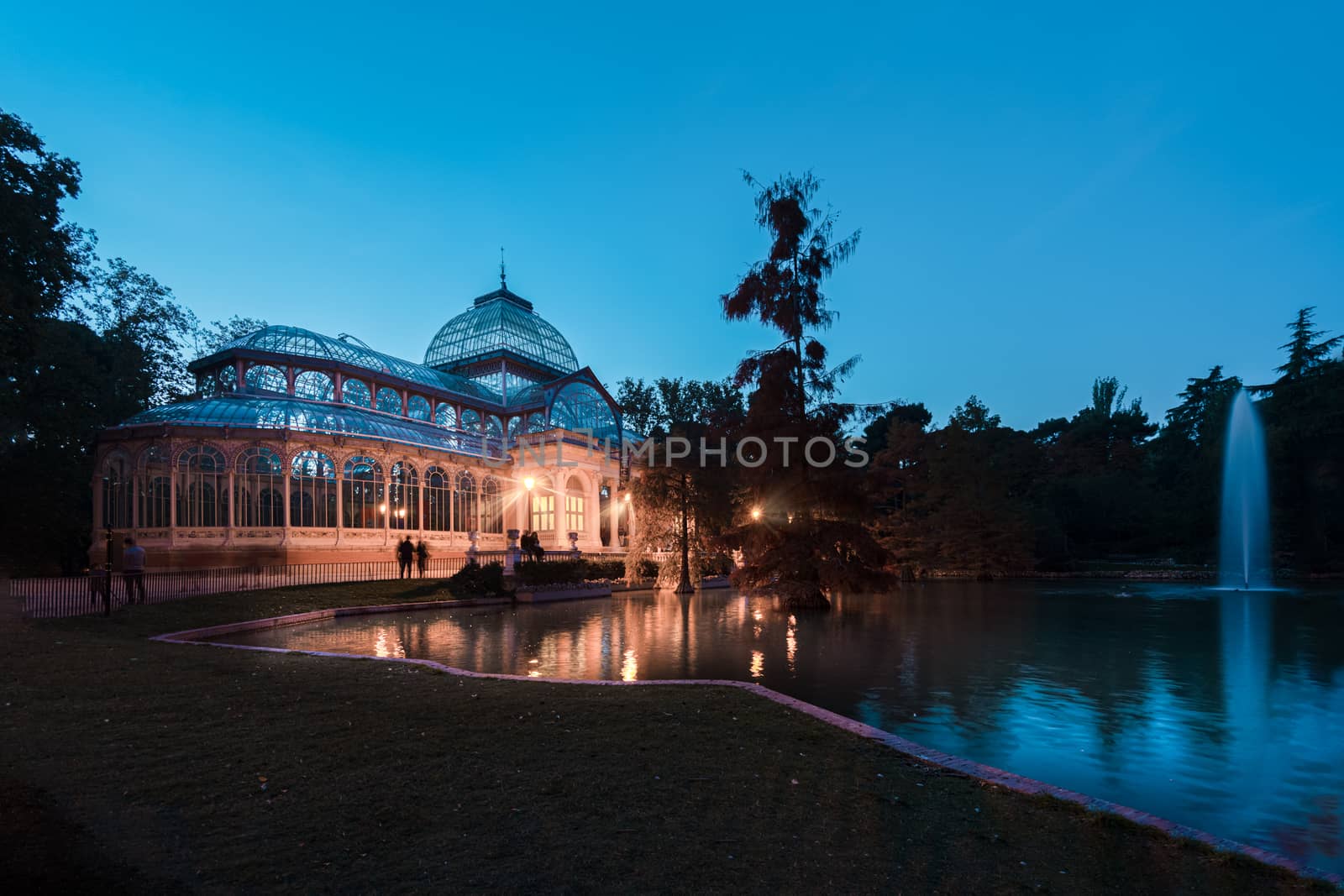 Blue hour view of Crystal Palace or Palacio de cristal in Retiro Park in Madrid, Spain. The Buen Retiro Park is one of the largest parks of the city of Madrid, Spain