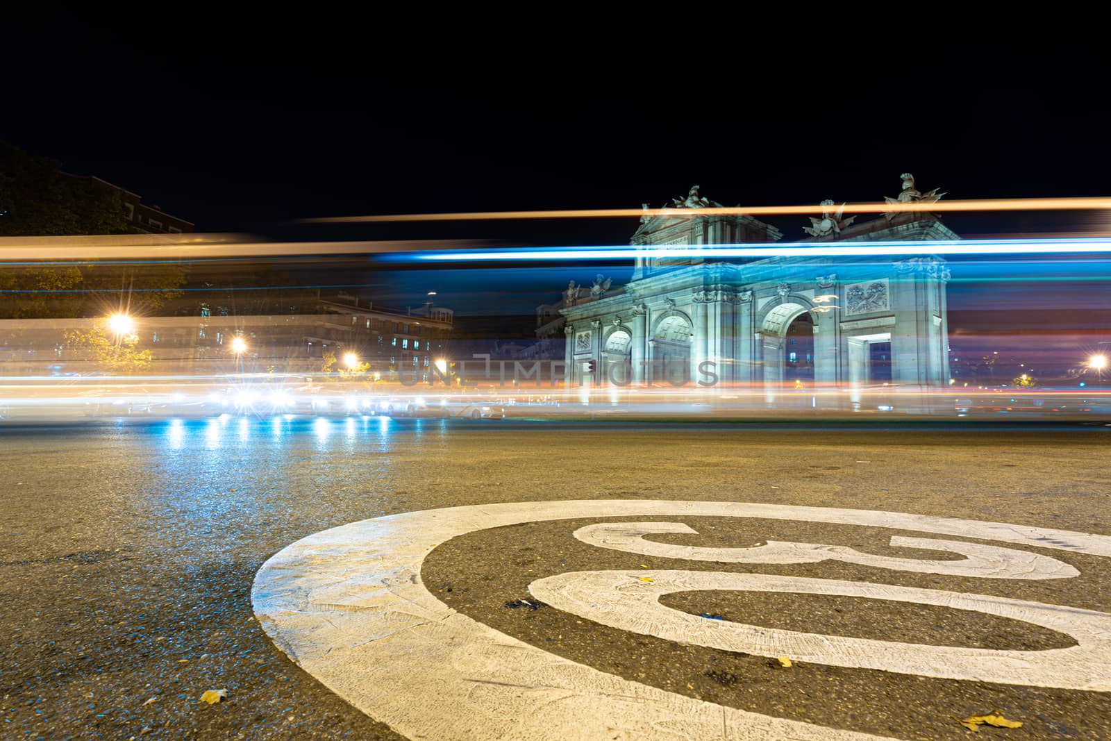 Night view of Puerta de Alcala with traffic lights in Madrid, Spain. by tanaonte