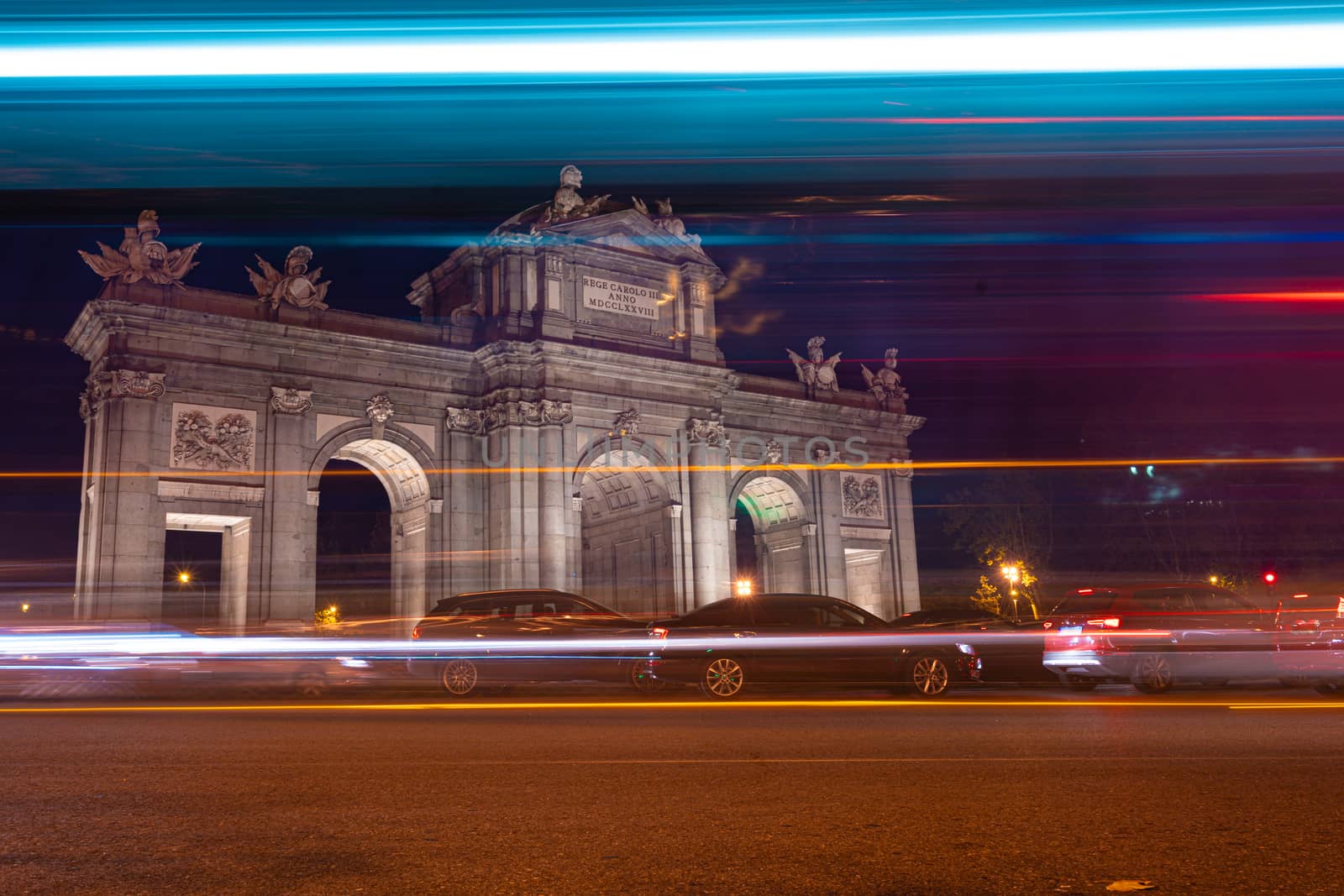 Night view of Puerta de Alcala with traffic lights in Madrid, Spain. by tanaonte