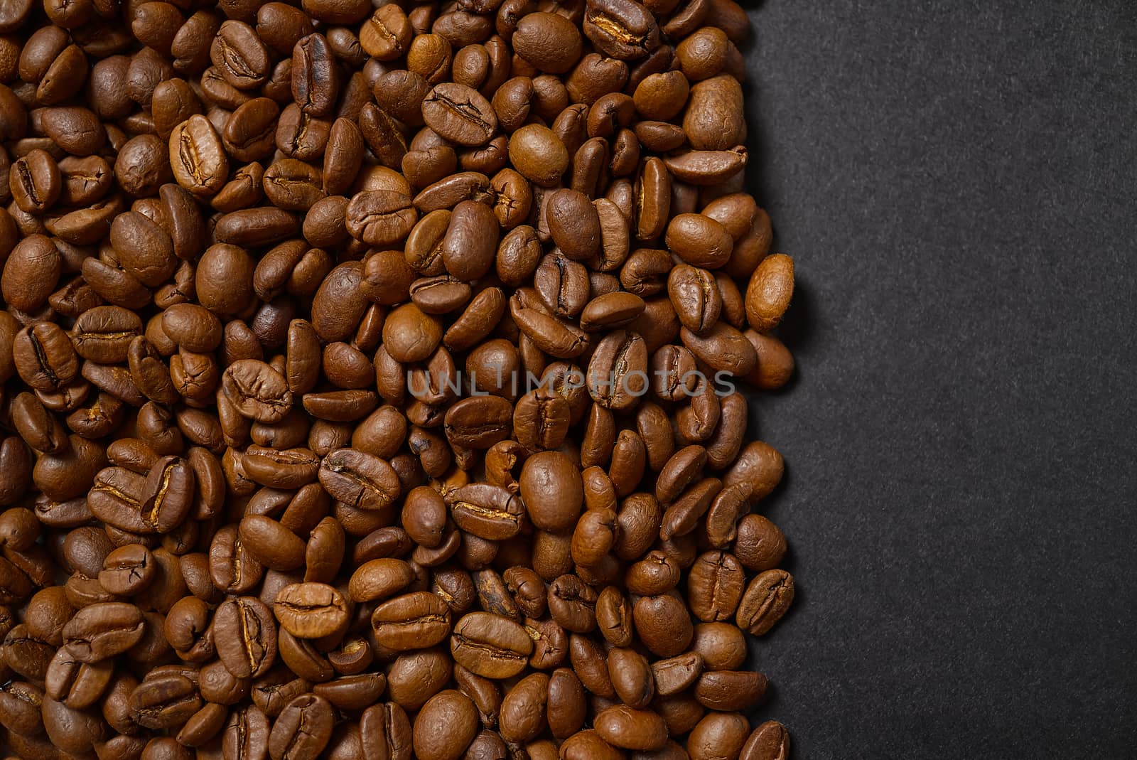 Texture of coffee beans. Roasted coffee beans background. close up Coffee beans with copy space on Black background by PhotoTime