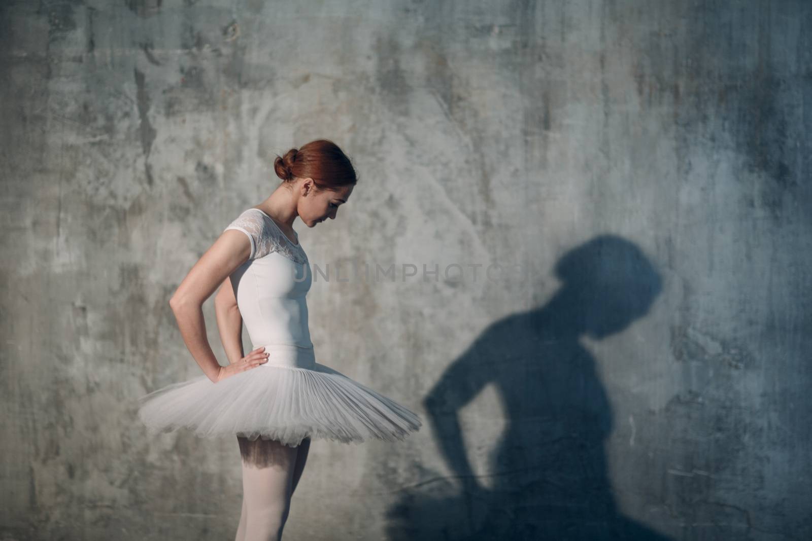 Ballerina female. Young beautiful woman ballet dancer, dressed in professional outfit, pointe shoes and white tutu. by primipil