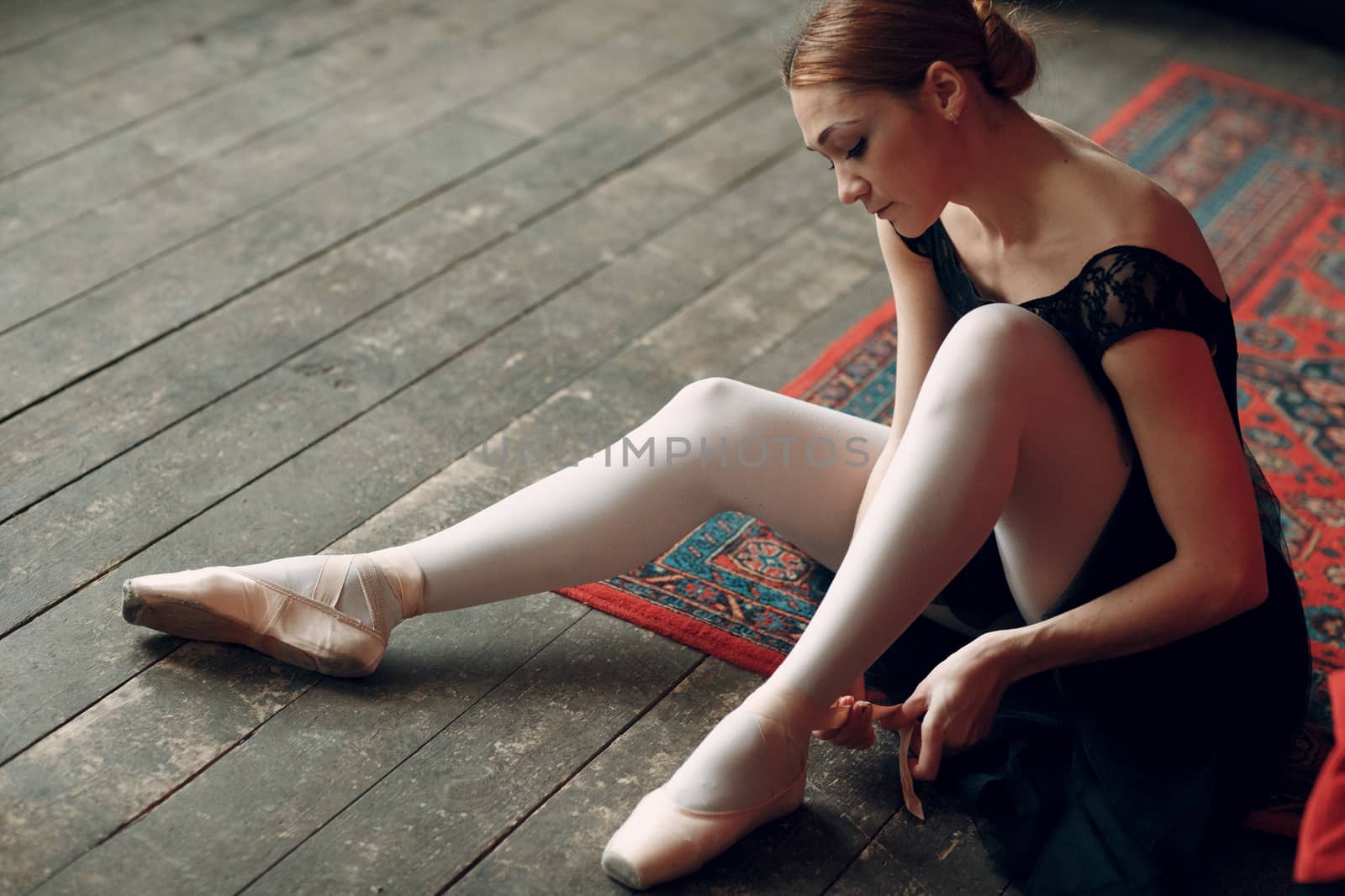 Ballerina female. Young beautiful woman ballet dancer, dressed in professional outfit, pointe shoes and black tutu.