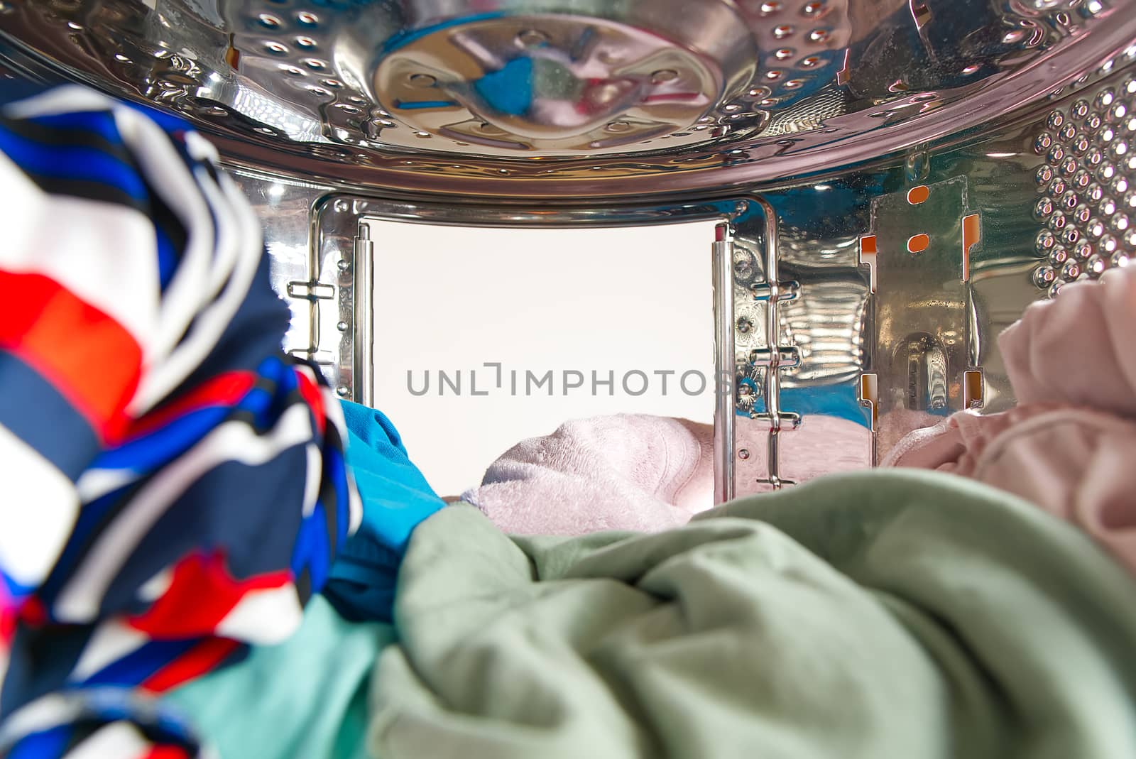 Washing machine with dirty clothes inside, studio shot. photo from inside the washing machine.