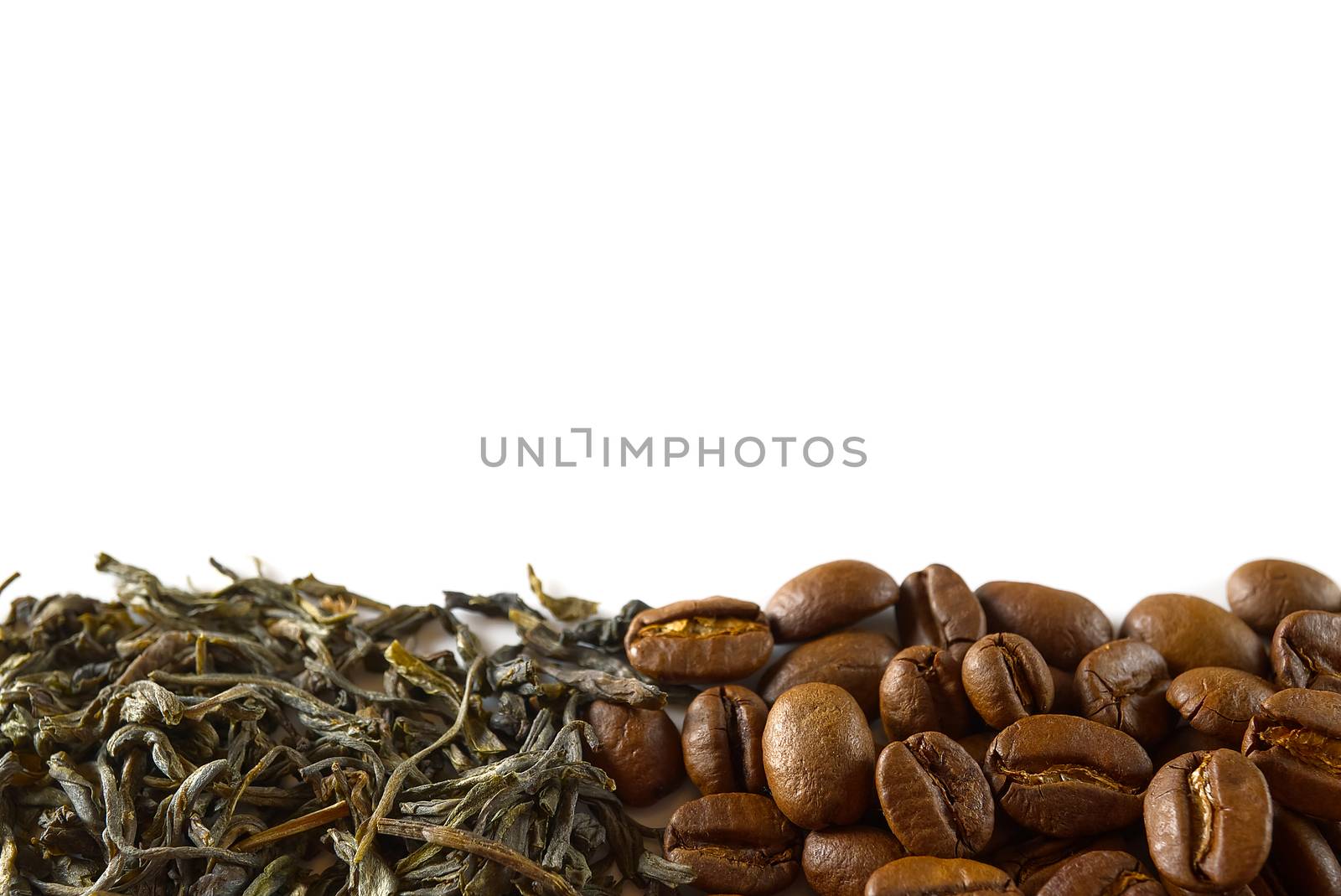 Pile of coffee beans and dry green tea leaves isolated on white background. closeup, copy space for your text.