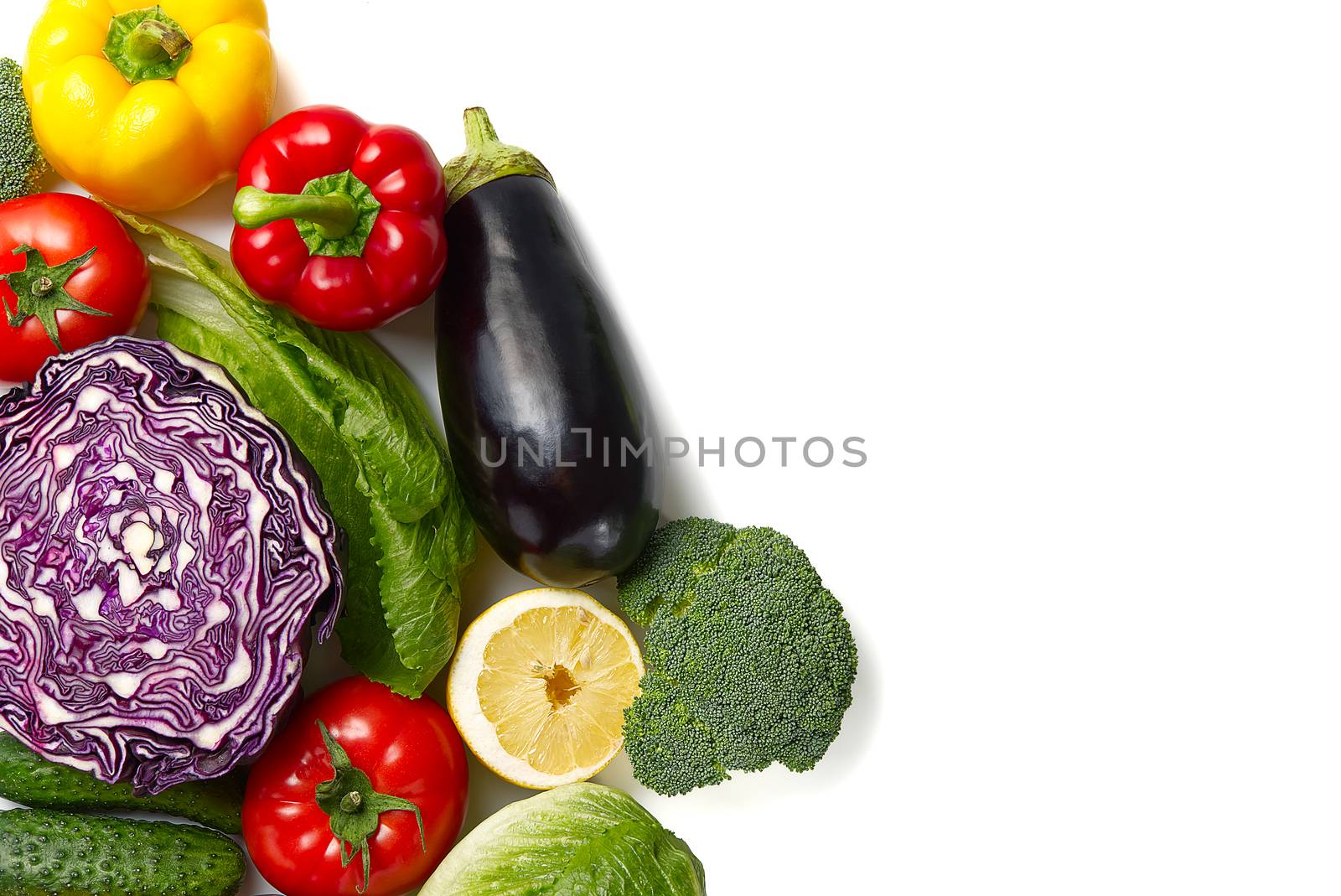 Food background border frame of colorful fresh produce raw vegetables, cucumber purple cabbage spinach tomatoes paprika onion broccoli herb, plenty of copy-space. Domestic kitchen. Vegetarian food