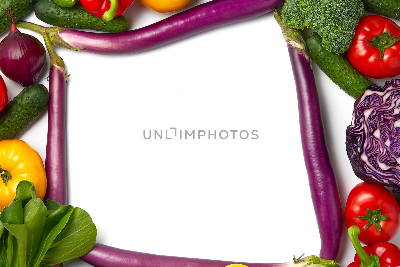 Blank piece of paper is lying on a vegetables layout with different kinds of vegetables. Mock up . Food background border frame of colorful fresh vegetables. Domestic kitchen. Vegetarian food