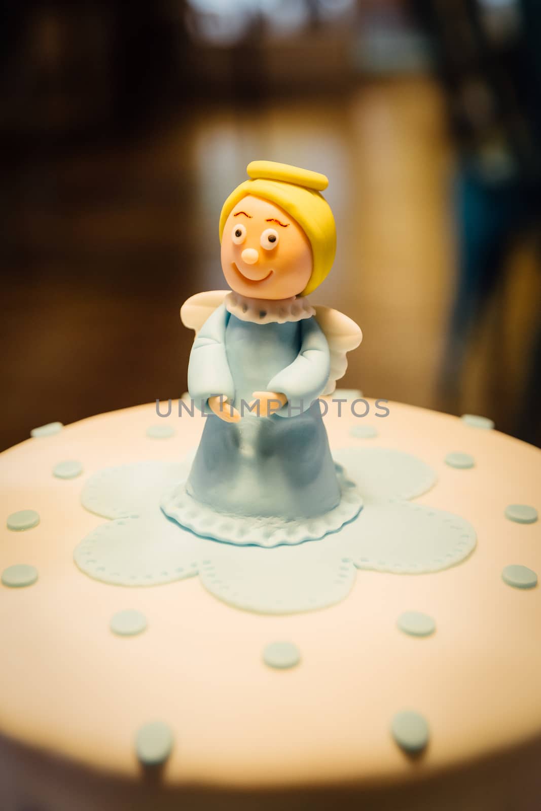 Angel made of sugar paste on a fondant cake.