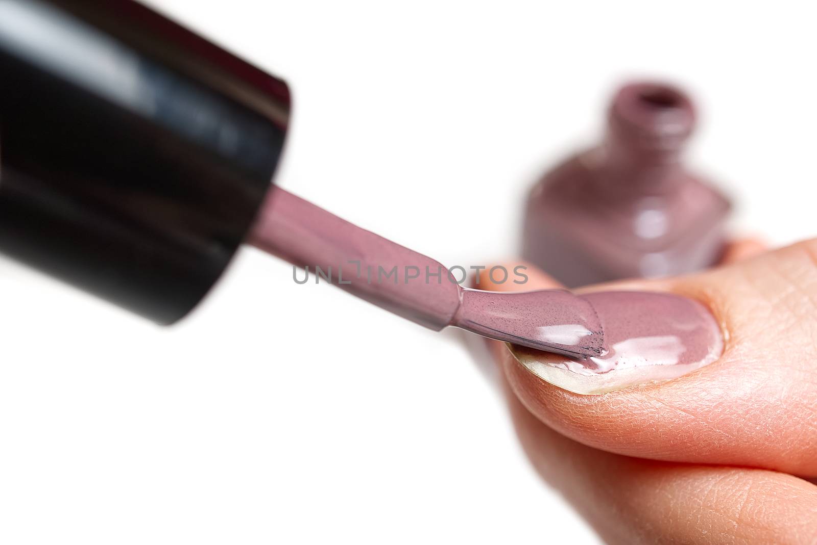 Woman applying nail polish. Beautiful nails. Woman applying polish on nails at home. Pastel nail polish on fingernail. Beauty treatment and hand care concept. manicure procedures yourself at home.