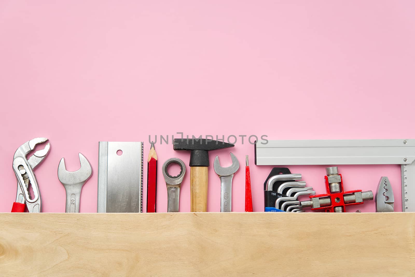 Home maintenance, service, diy concept. Tools for wood, metal and other construction work. Top view on DIY tools. home repairs. on pink background