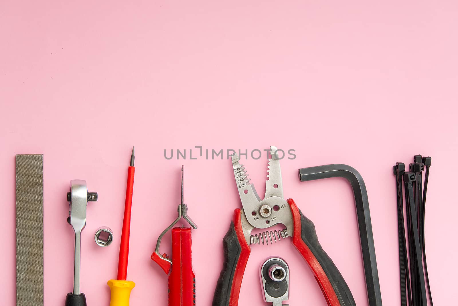 Home maintenance, service, diy concept. Tools for wood, metal and other construction work. Top view on DIY tools. home repairs. on pink background