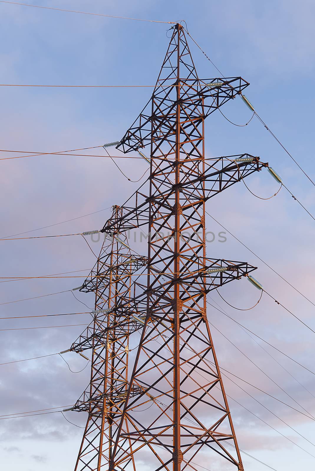 A high-voltage electricity tower. A High-voltage power transmission tower. Power engineering. by PhotoTime