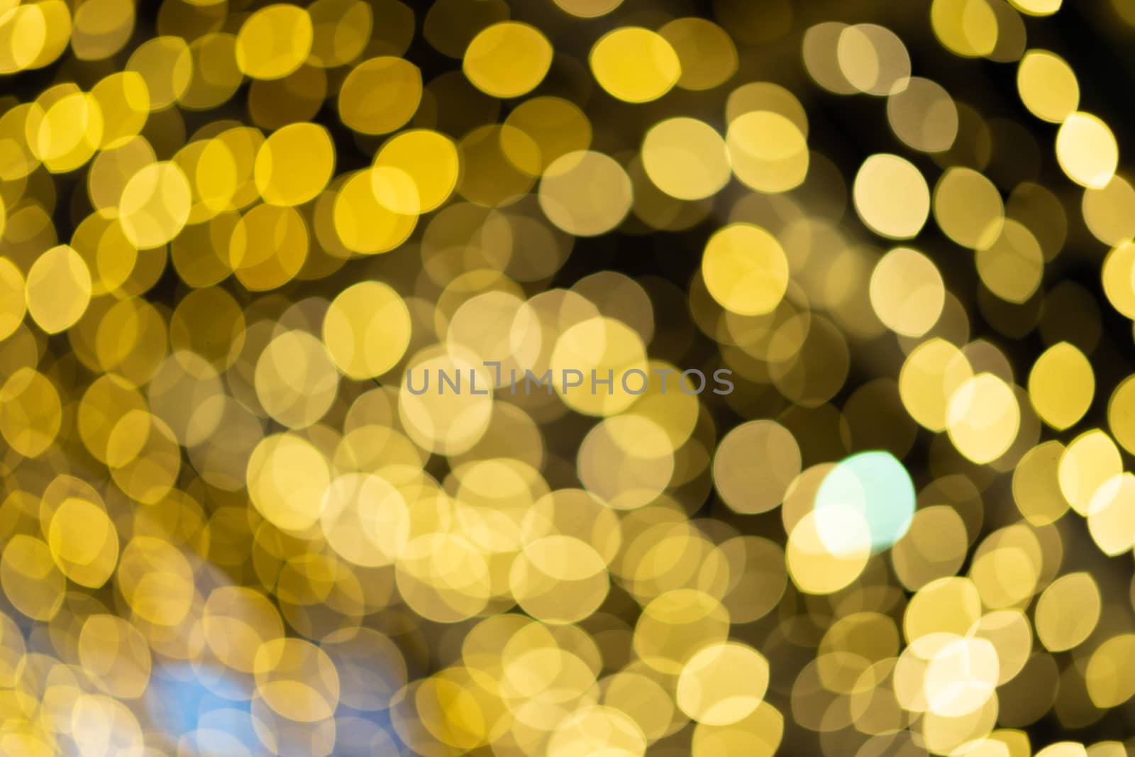 Golden beautiful blurred bokeh background with copy space. Glitter yellow light spots defocused by tanaonte