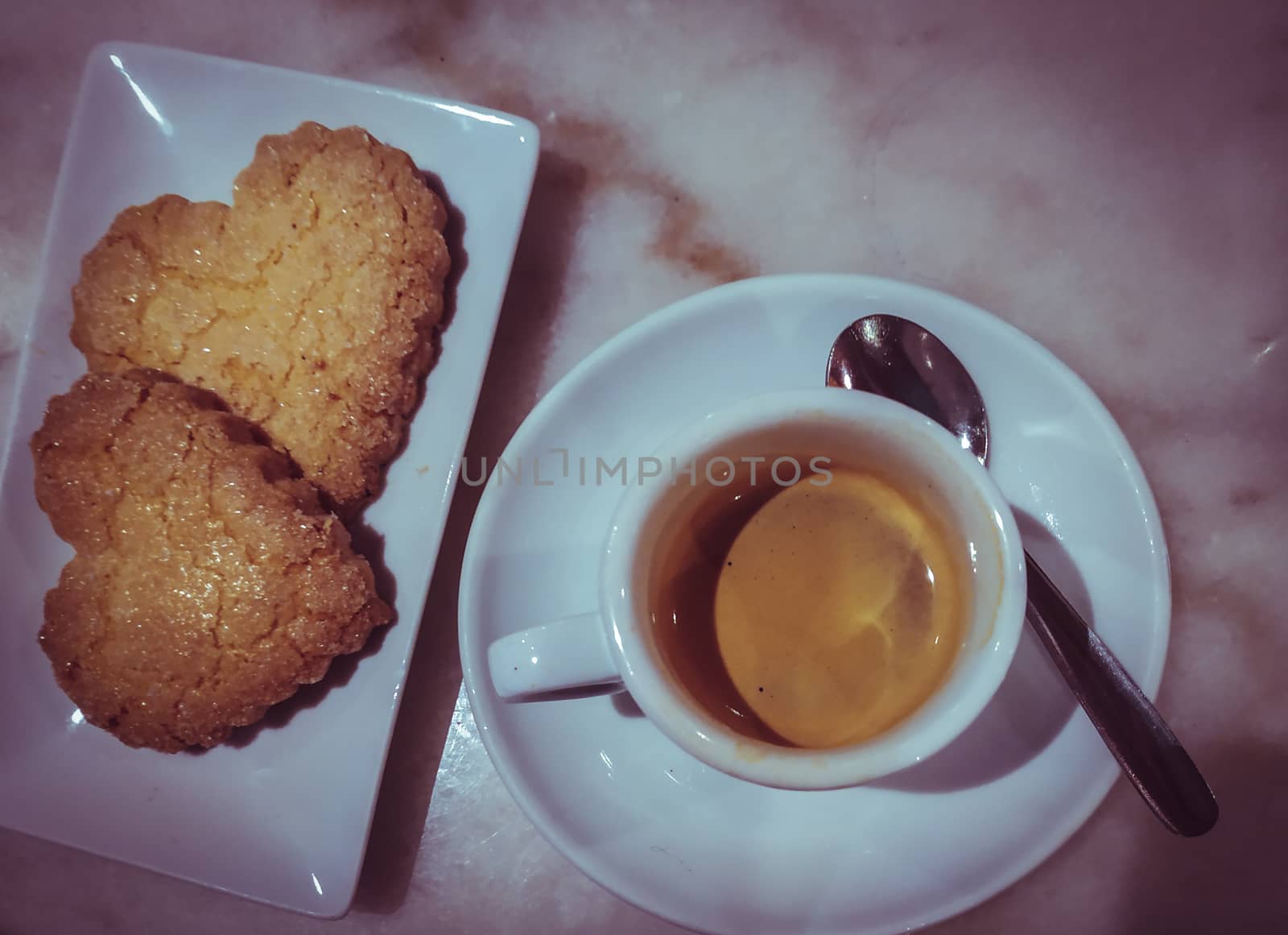 Heart cookies with cup of coffee in a real coffee shop by tanaonte