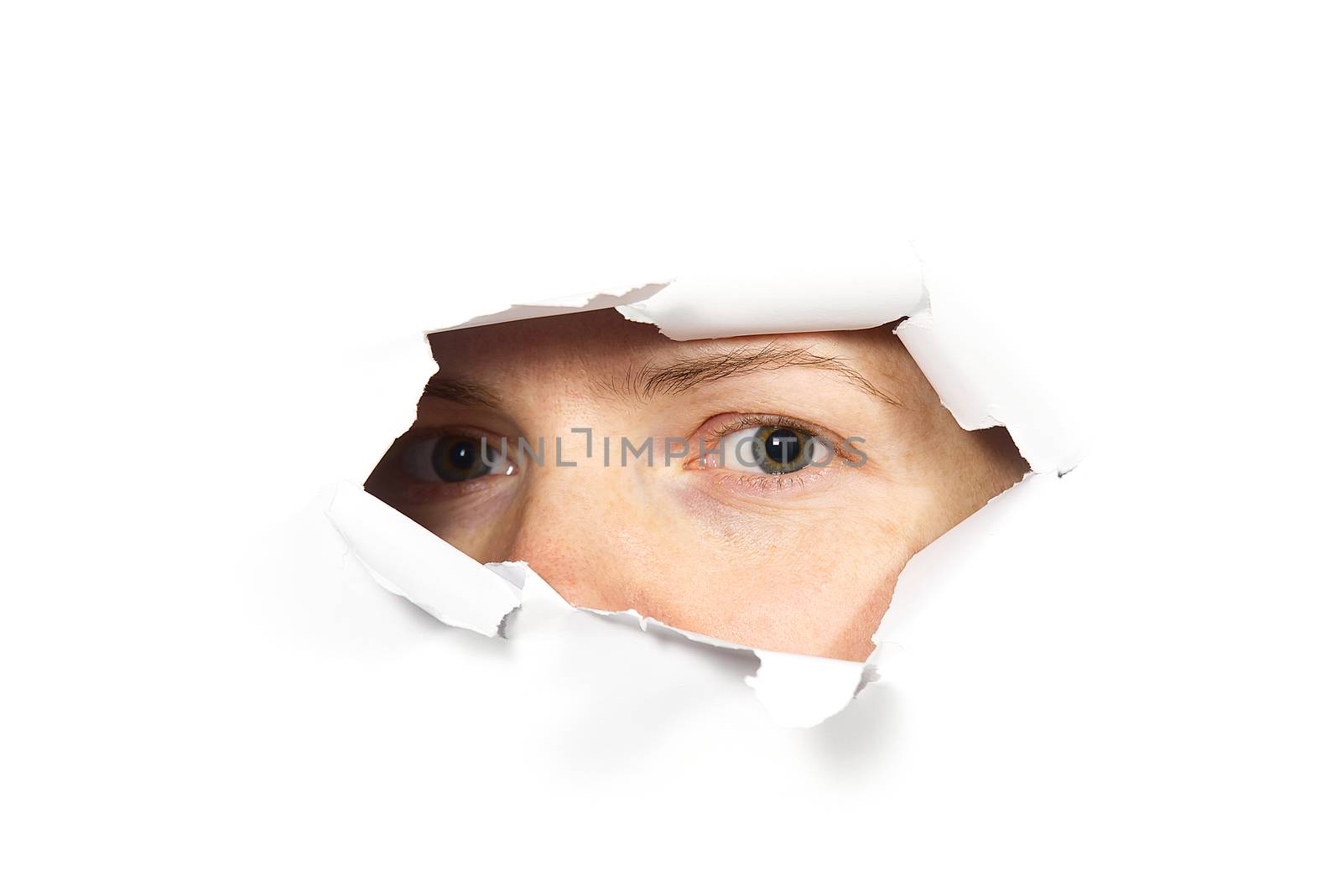 Young woman peeping through hole on paper. Female Eye looking through hole. Isolated on white background. Spy concept.