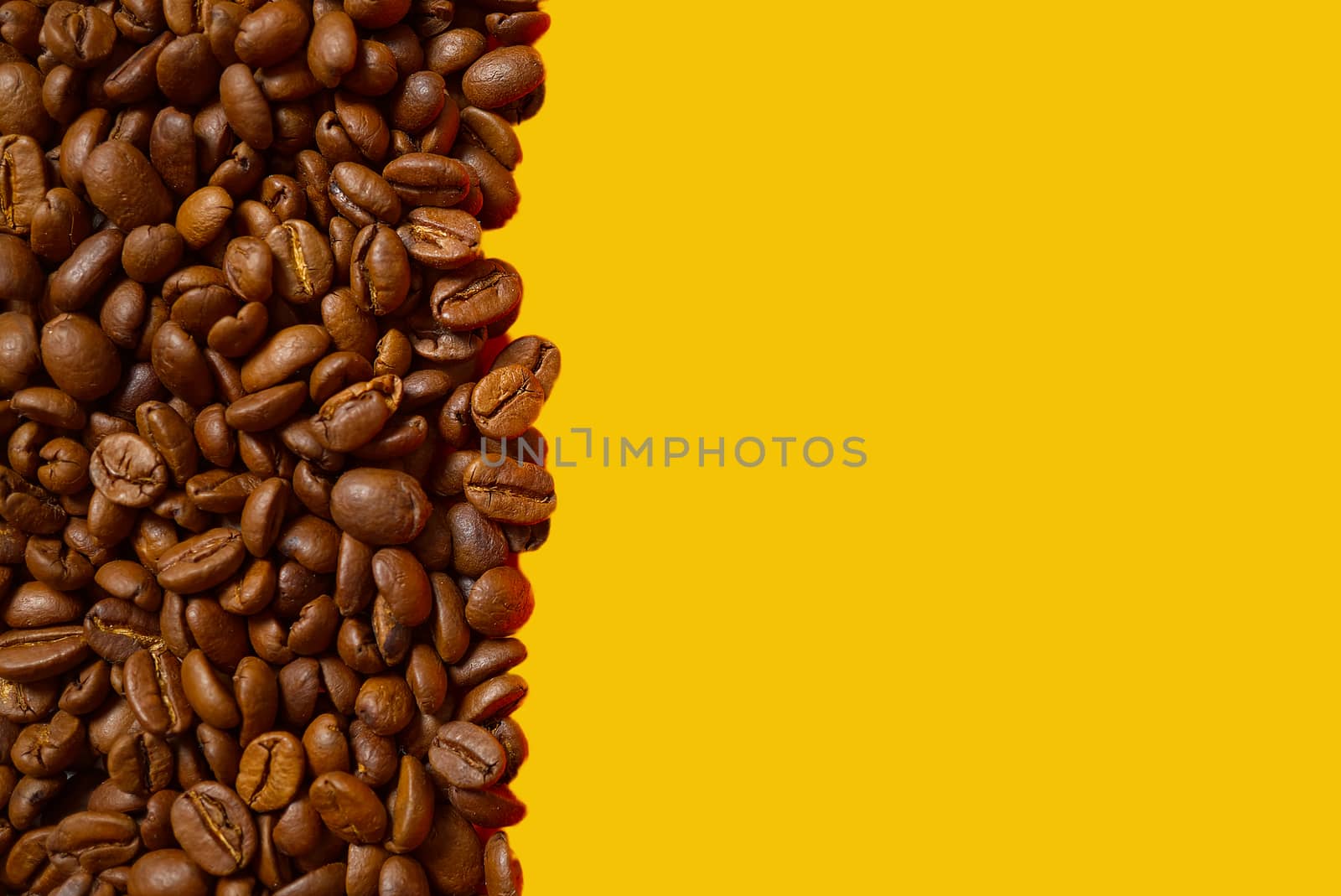 Texture of coffee beans. Roasted coffee beans background. close up Coffee beans with copy space on orange background by PhotoTime