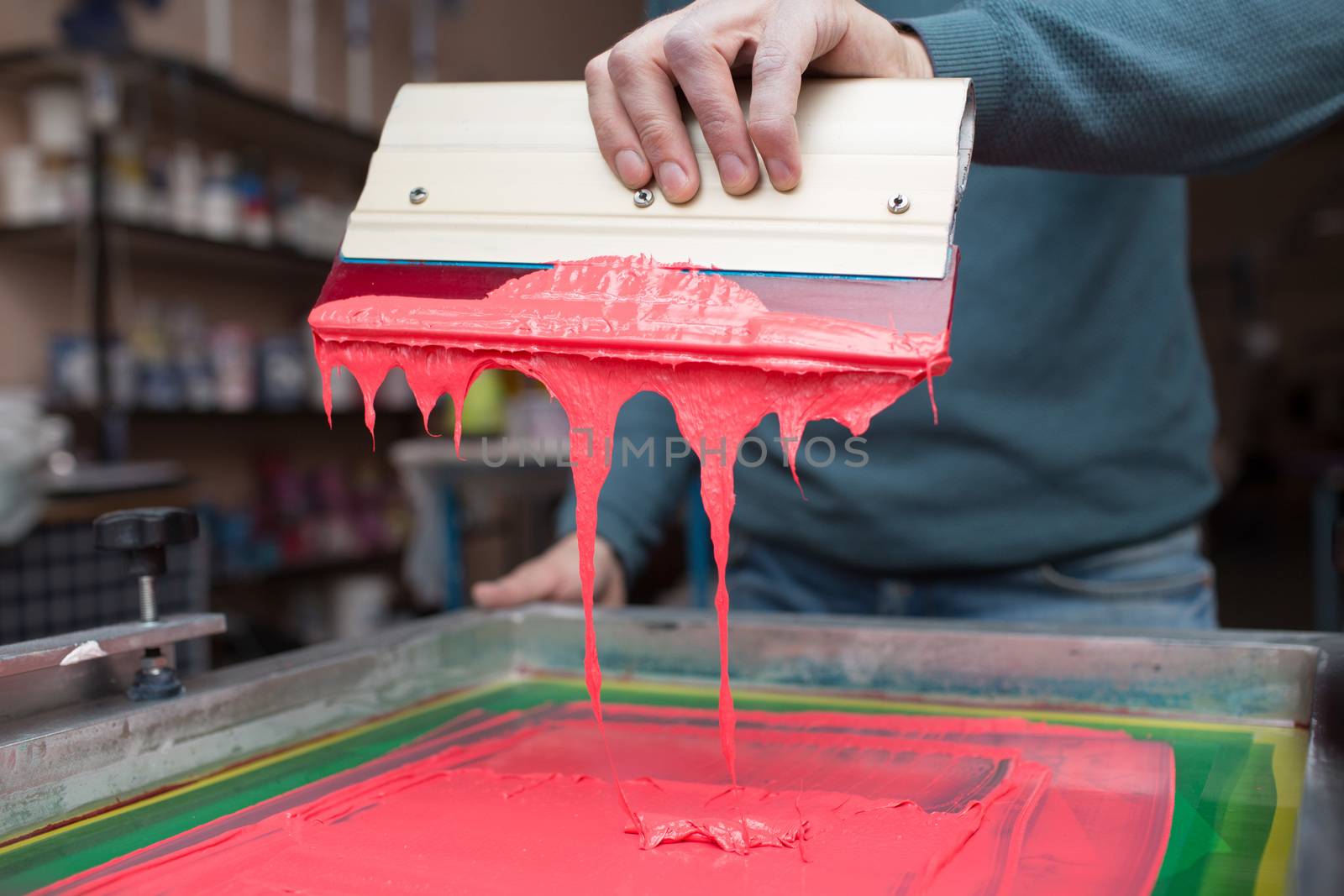 Silk screen printing. Serigraphy. Color paints and fabric. Plastisol paint and squeegee. by primipil