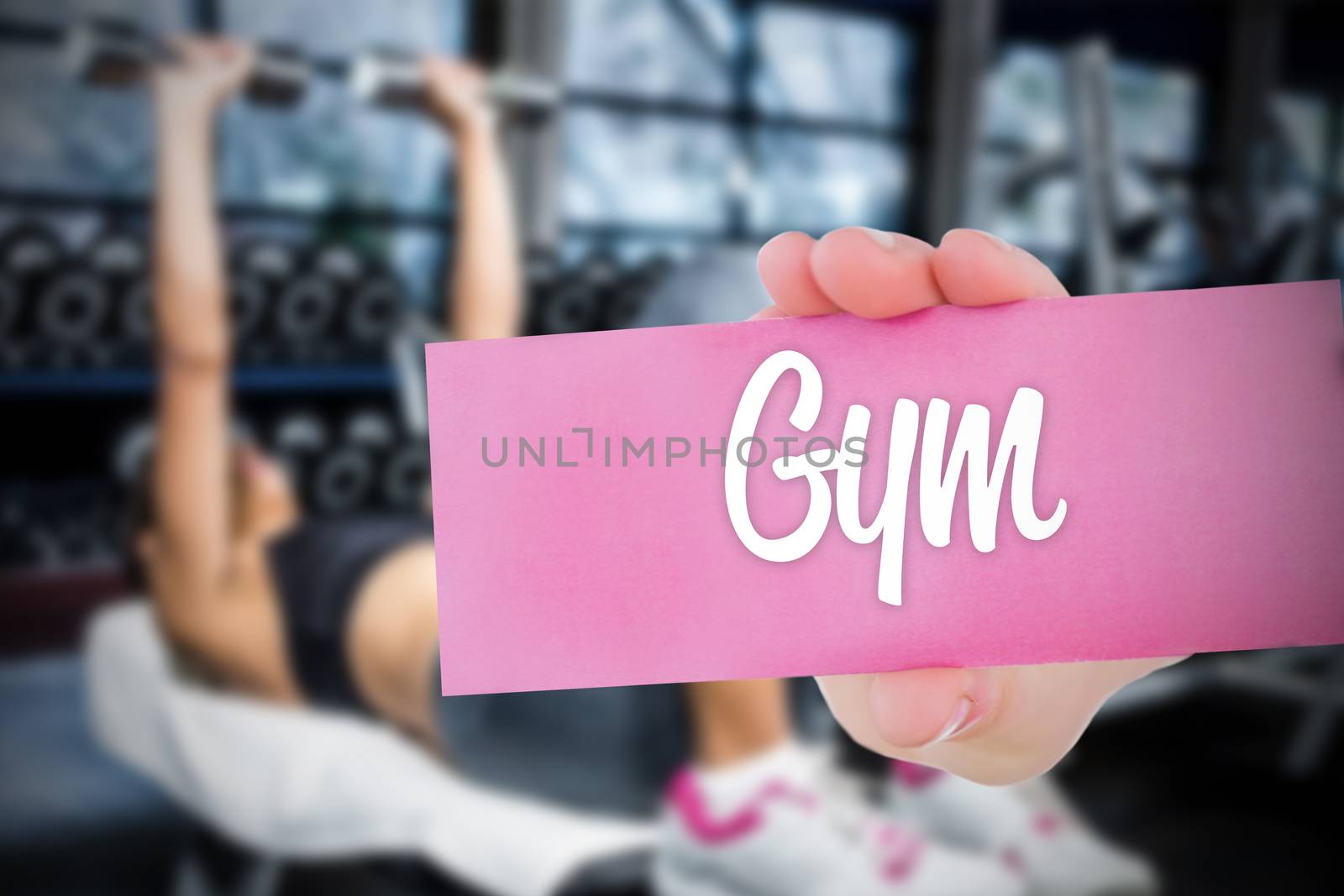 The word gym and young woman holding blank card against 