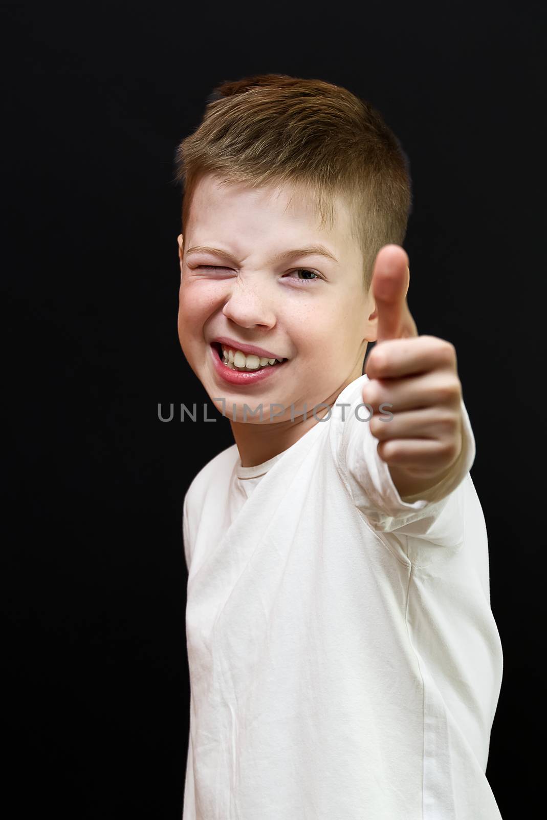 Portrait of happy boy showing thumbs up isolated one black. boy showing yes. Child's hand showing thumb-up. Happiness concept. by PhotoTime
