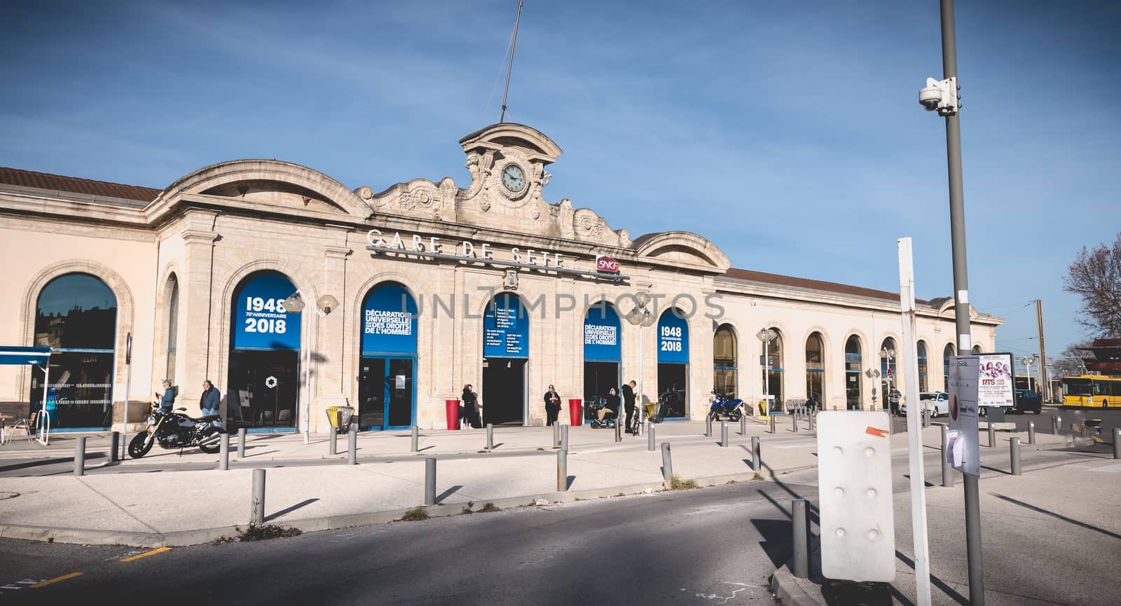 Sete, France - January 4, 2019: People are waiting or walking in front of the SNCF train station under renovation work in the city center on a winter day