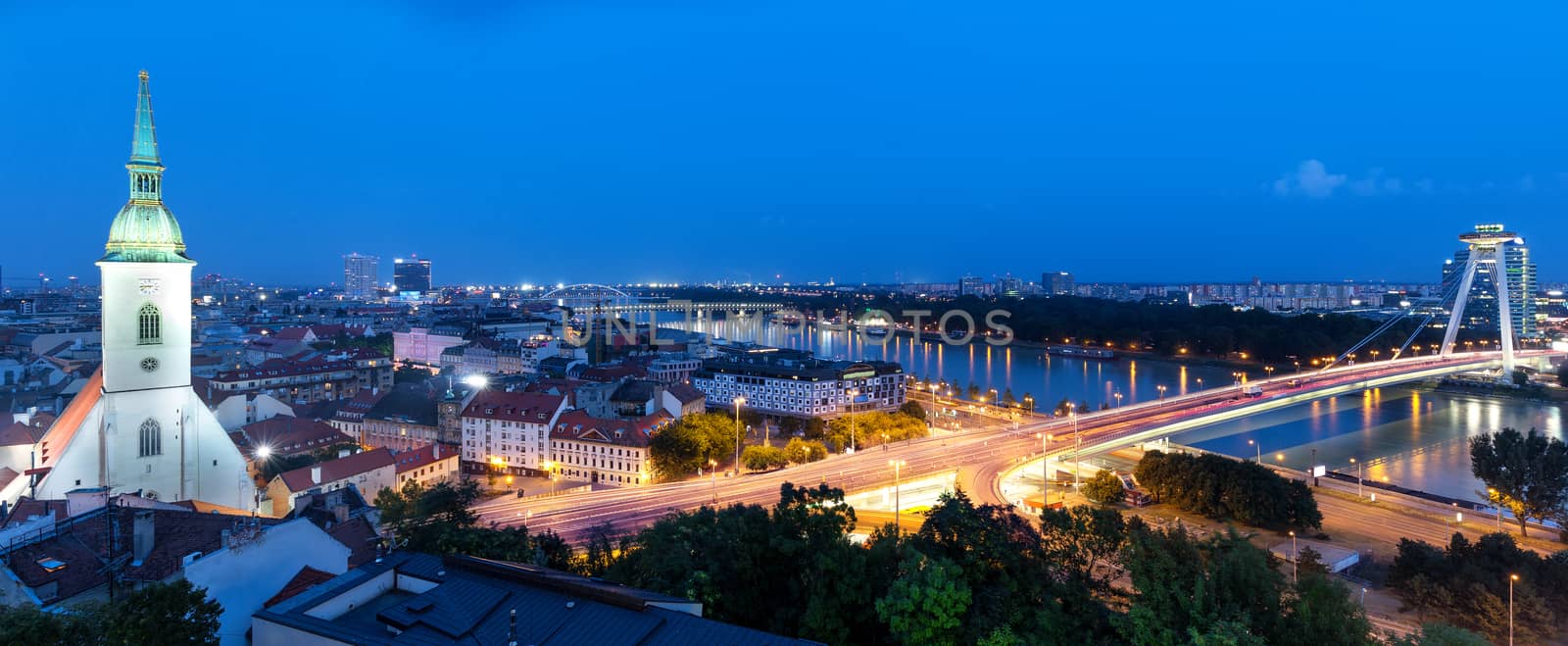 Panoramic view of Bratislava city with St. Martin's Cathedral and Danube river at night