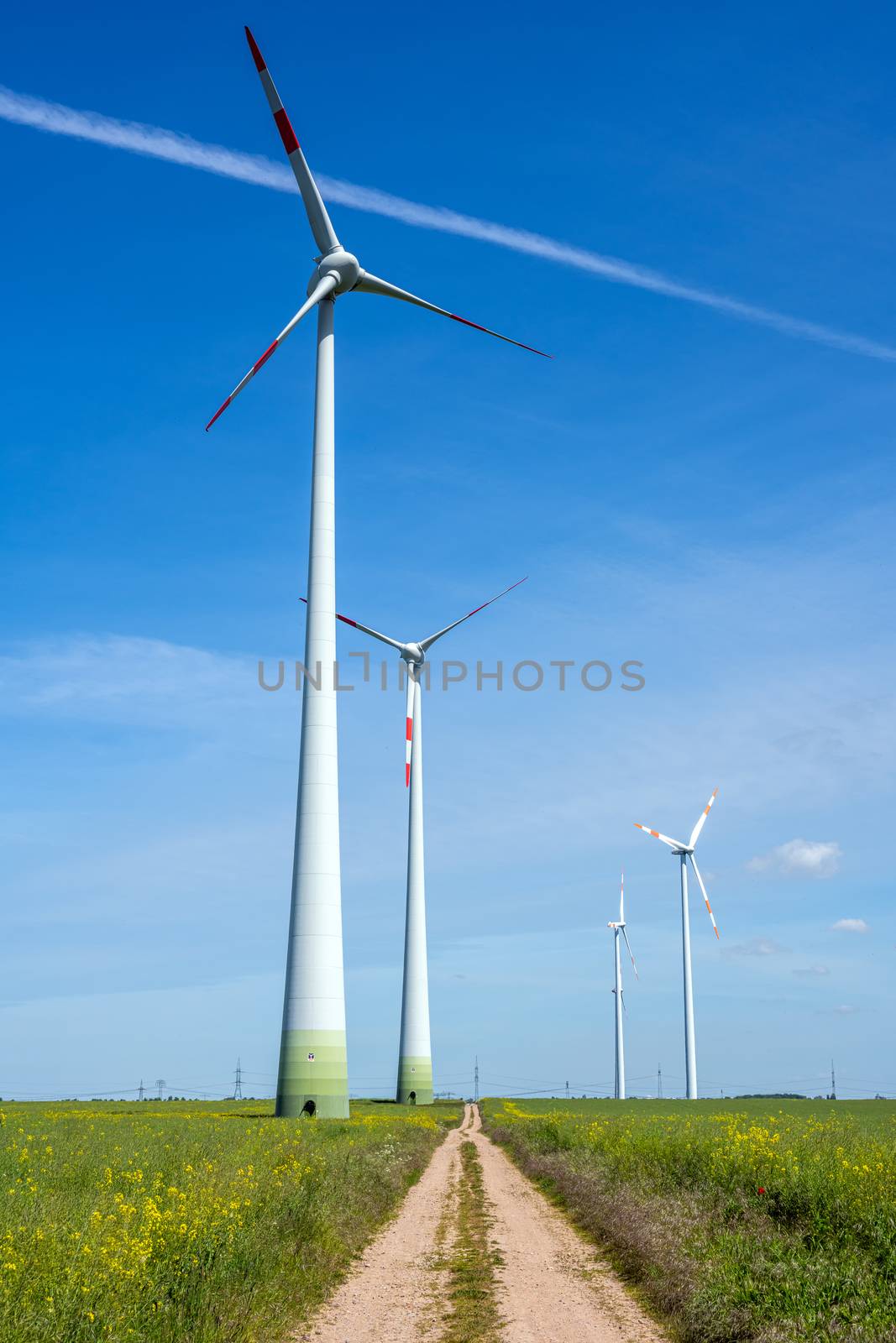 Modern wind energy generators and a country road seen in Germany