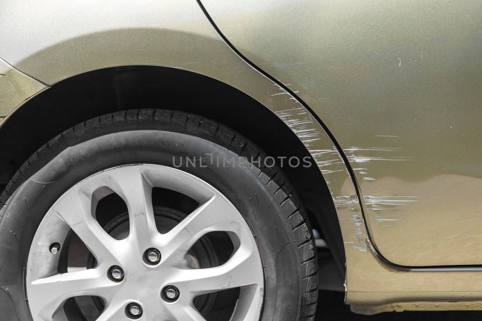 Car crash. Beside the deep green color car have scratch from damage on road. Close up scratch	