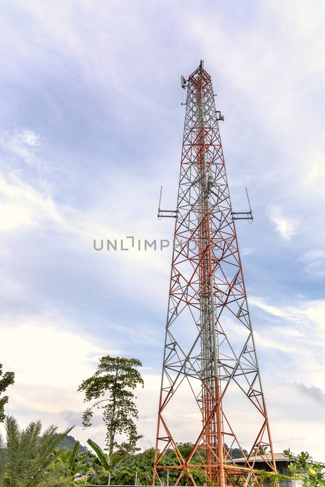 mobile phone communication and network signal repeater antenna tower with blue sky background