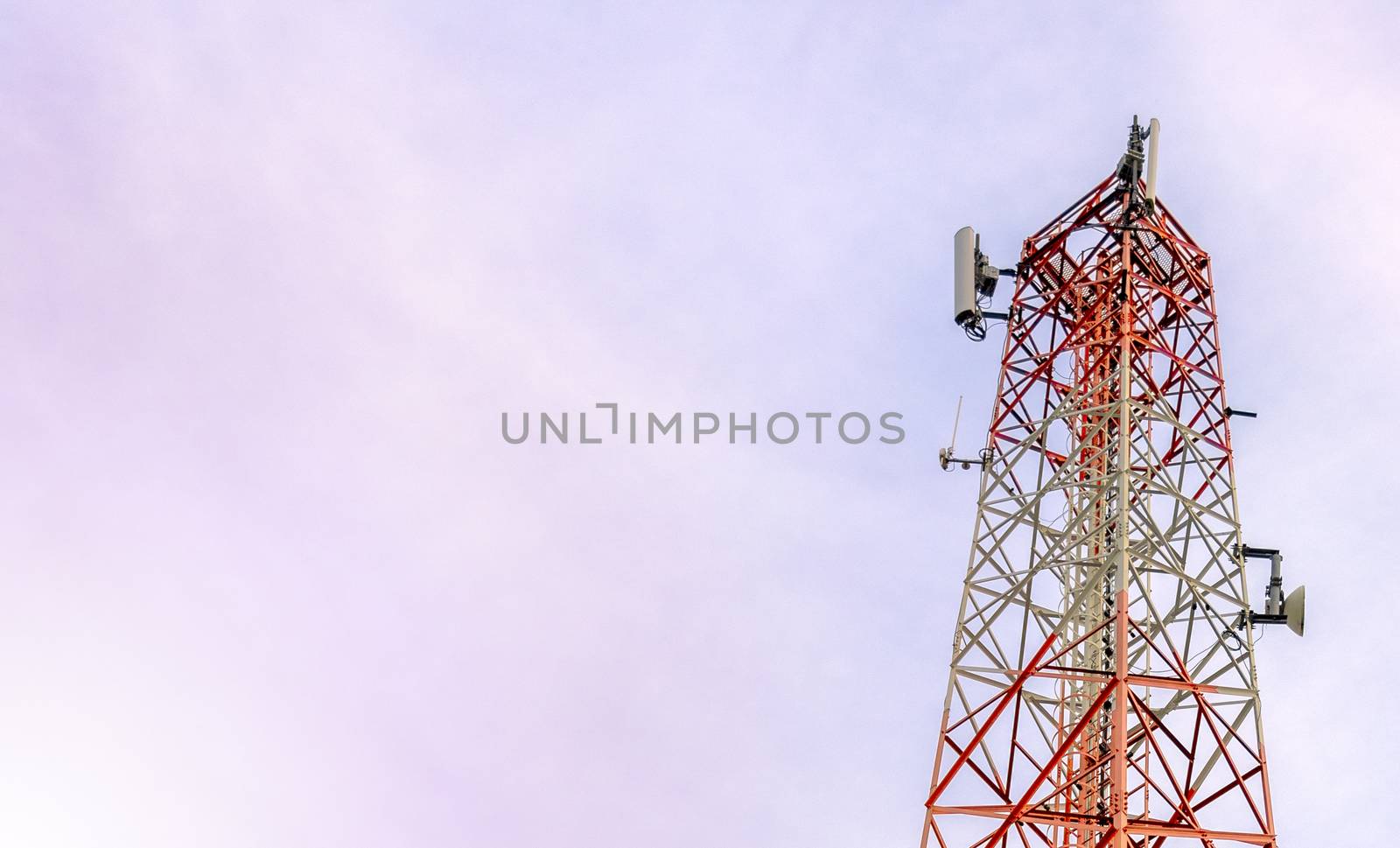 mobile phone communication and network signal repeater antenna tower with blue sky background. With copy space for text or design