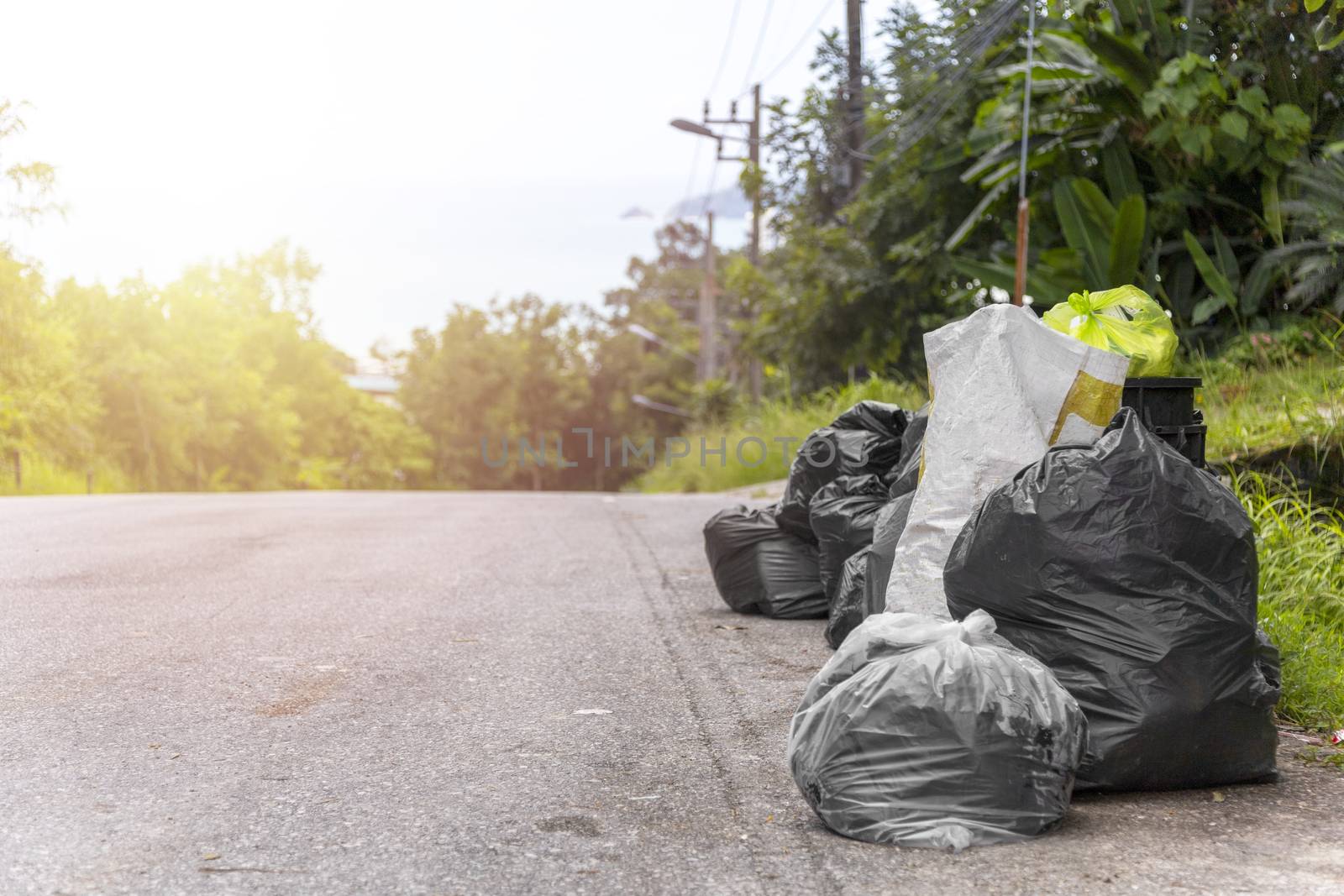 Big and many plastic garbage bag on streets with garbage sitting on ground