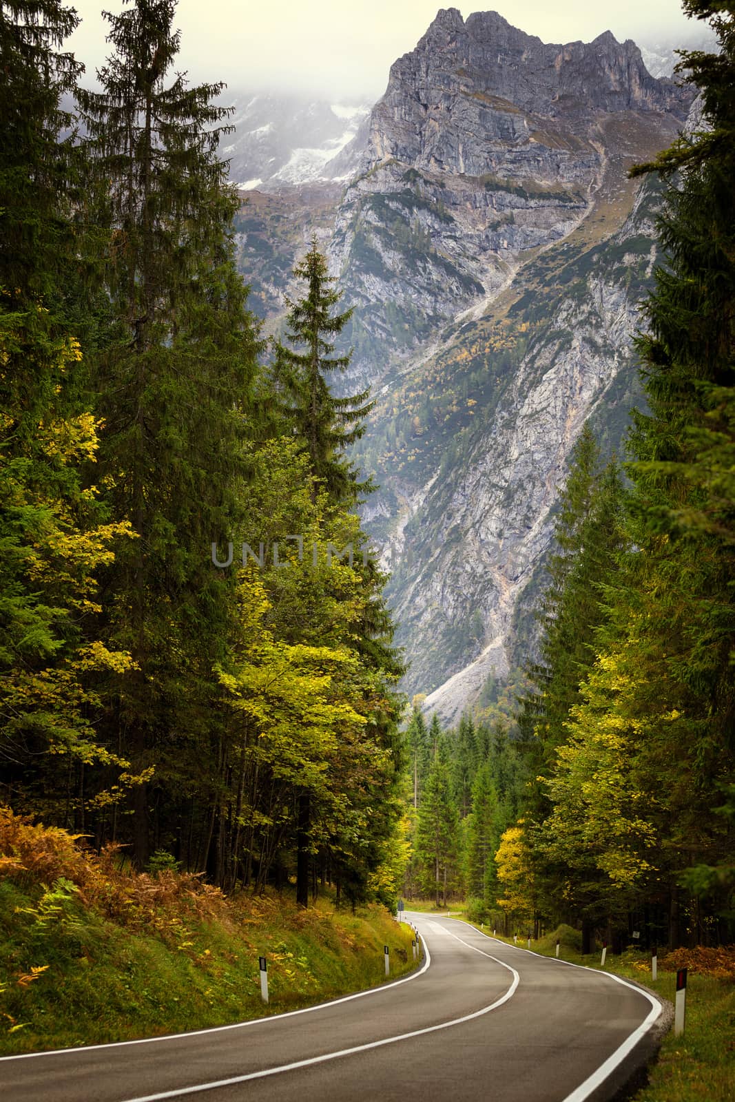 A road thru mountain pass in dolomites during autumn with beauti by necro79