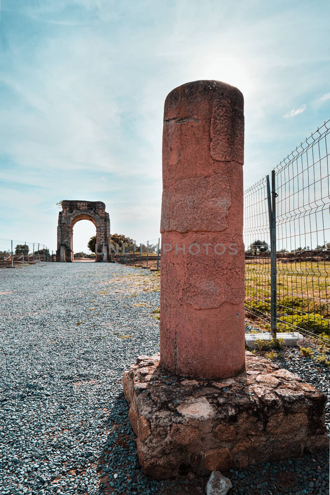 Column and Arch of Caparra, ancient roman city of Caparra in Extremadura, Spain by tanaonte
