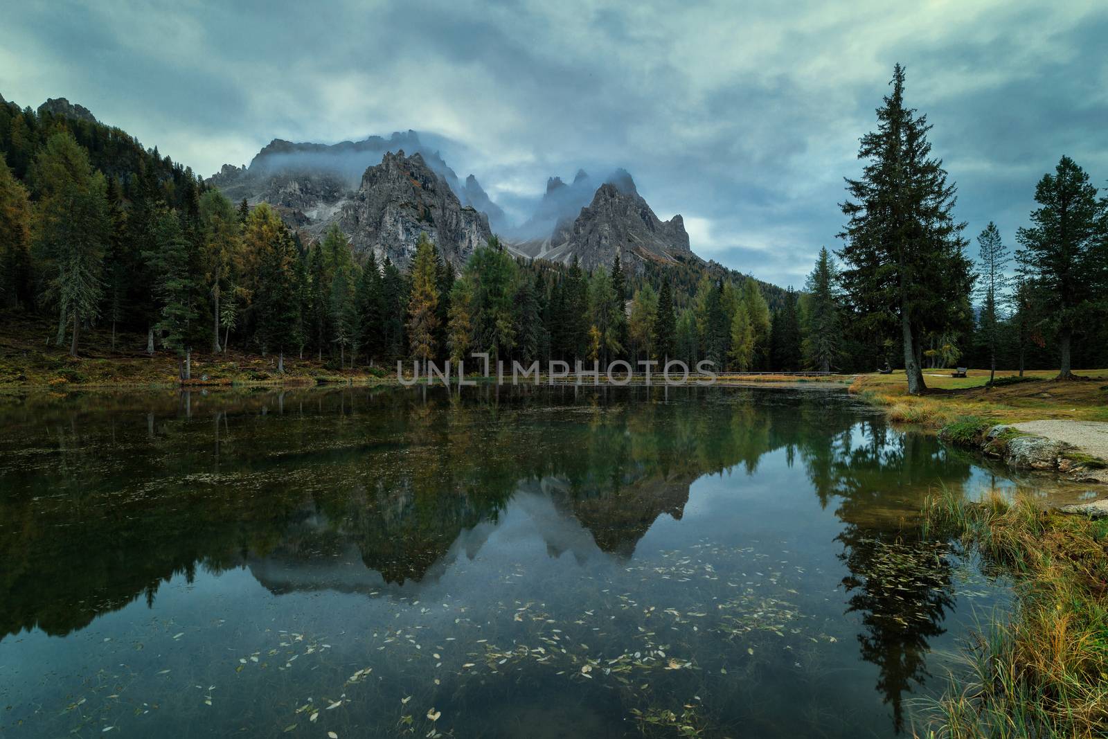 Cloudy morning at Antorno lake, warm morning colors and beautiful reflection. Italy, Europe