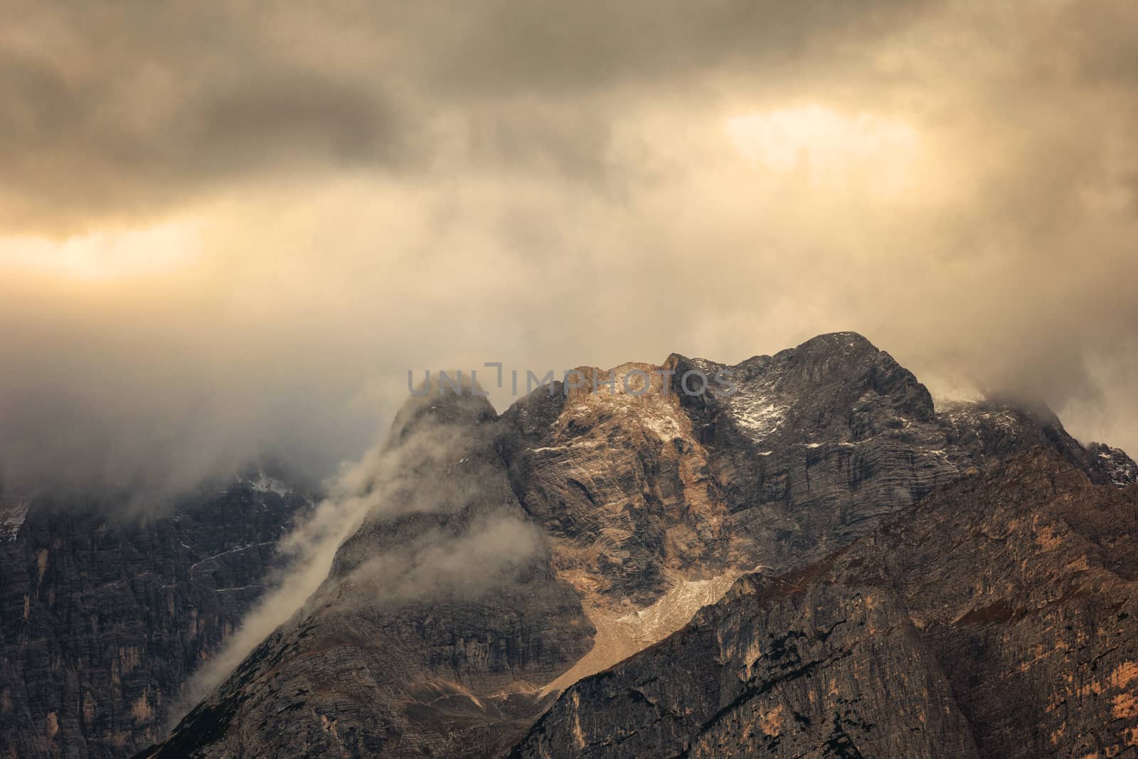 Punta Sorapis peaks at misurina lake in a cloudy morning at sunrise.