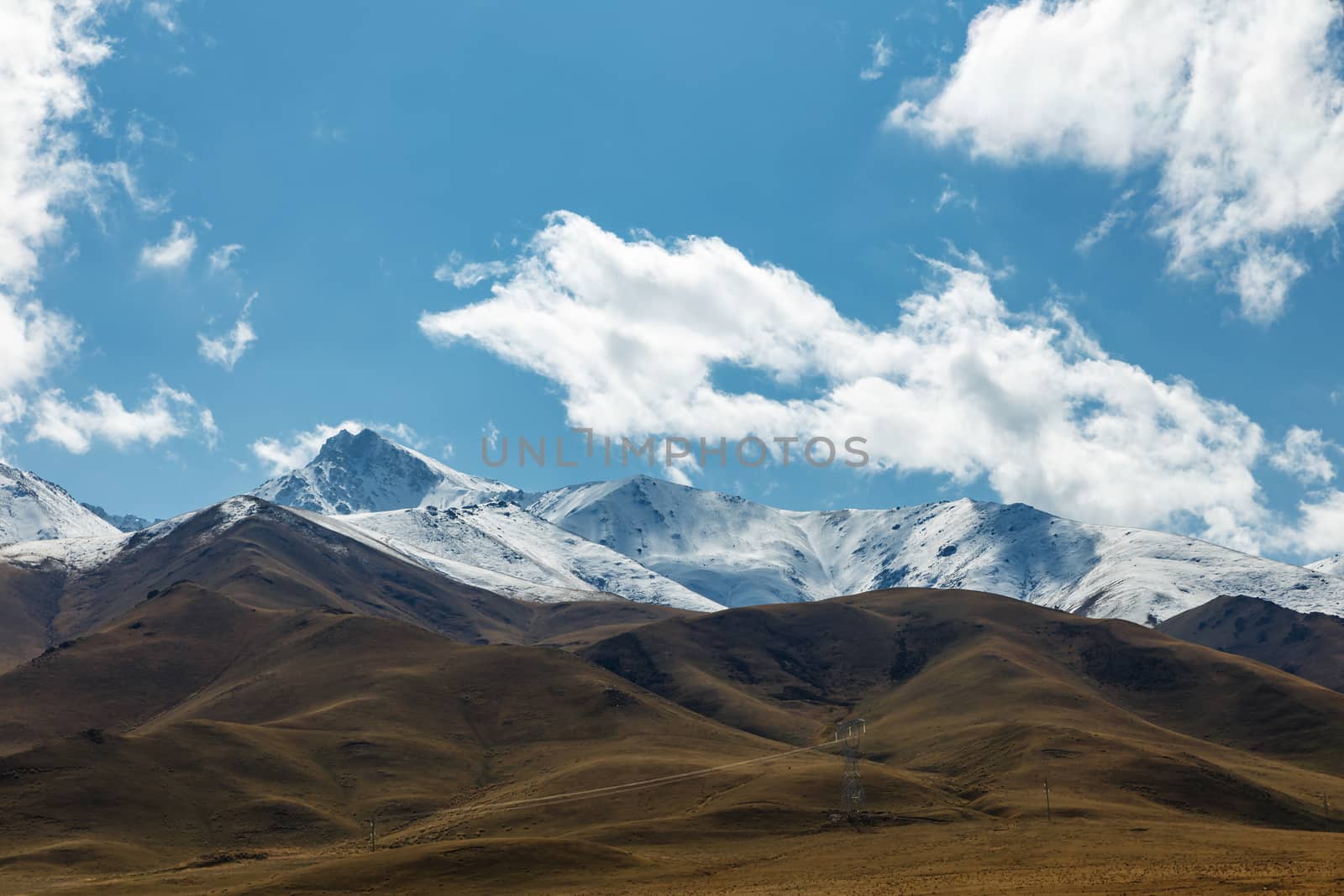 White clouds float over the mountains. Mountain landscape in Kyrgyzstan.