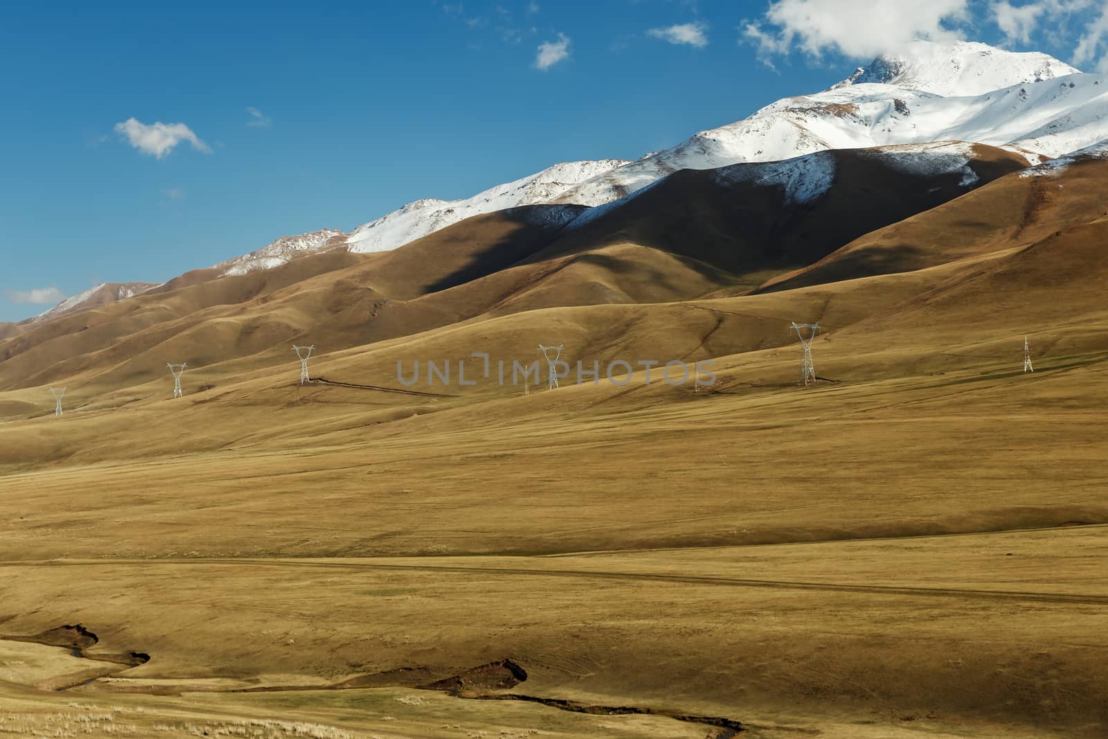 The snowy peaks of the mountains along which the power line passes in Kyrgyzstan.