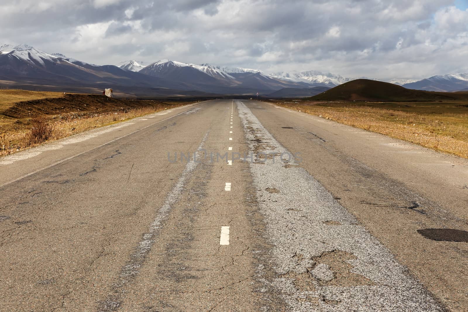 asphalt road, Bishkek Osh highway in Suusamyr valley of Kyrgyzstan.