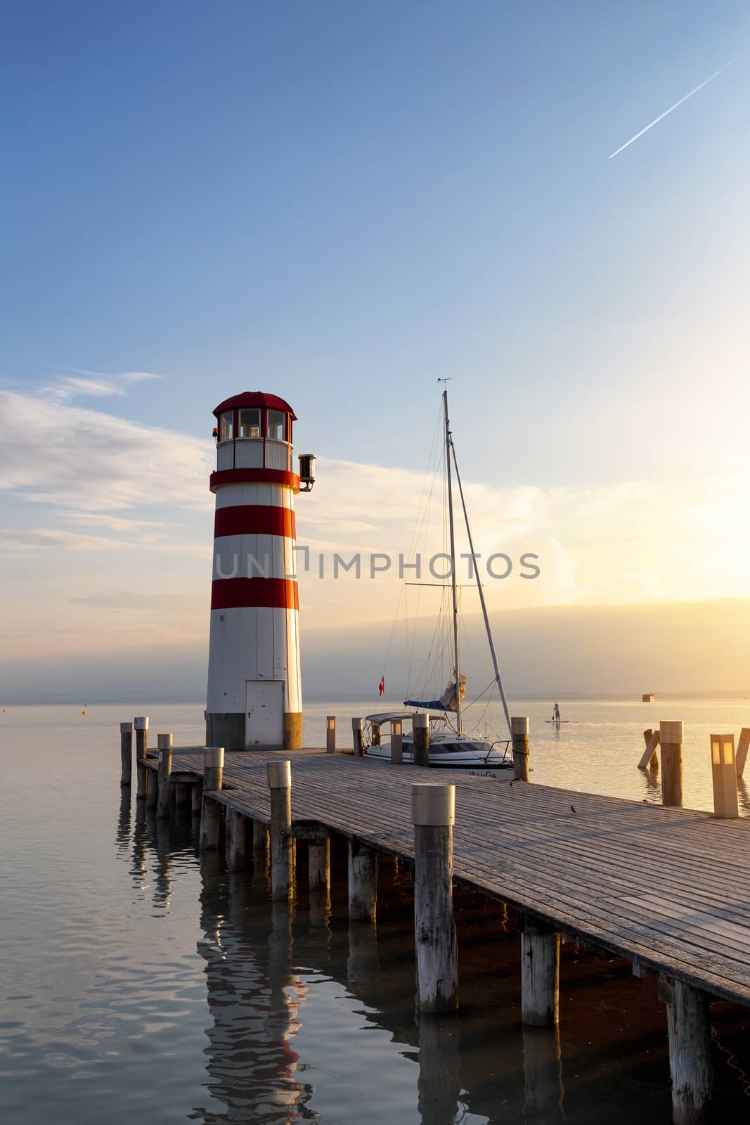 Lighthouse and a boat waiting for sunset