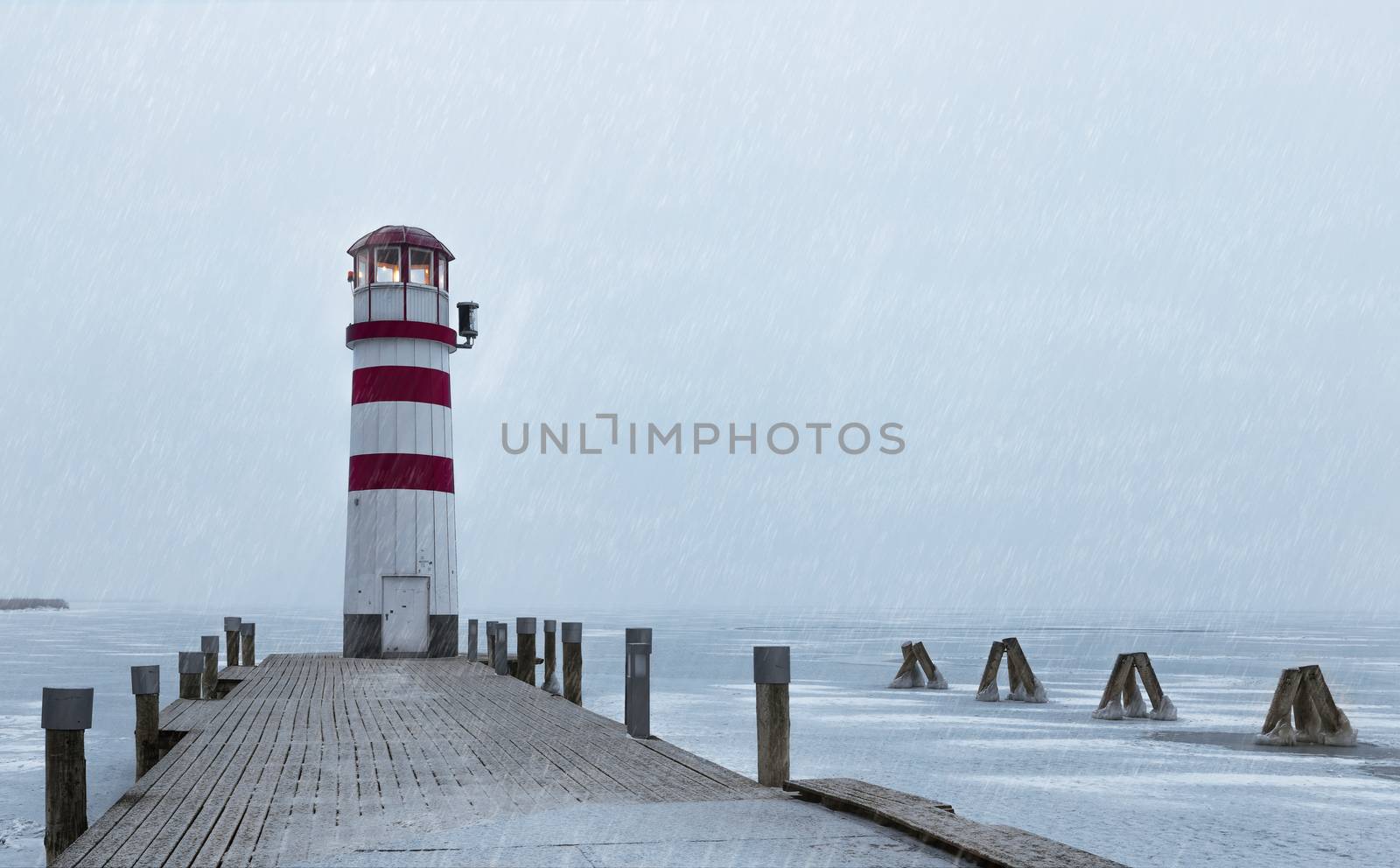 Lighthouse at sunrise with fog and rain during winter by necro79