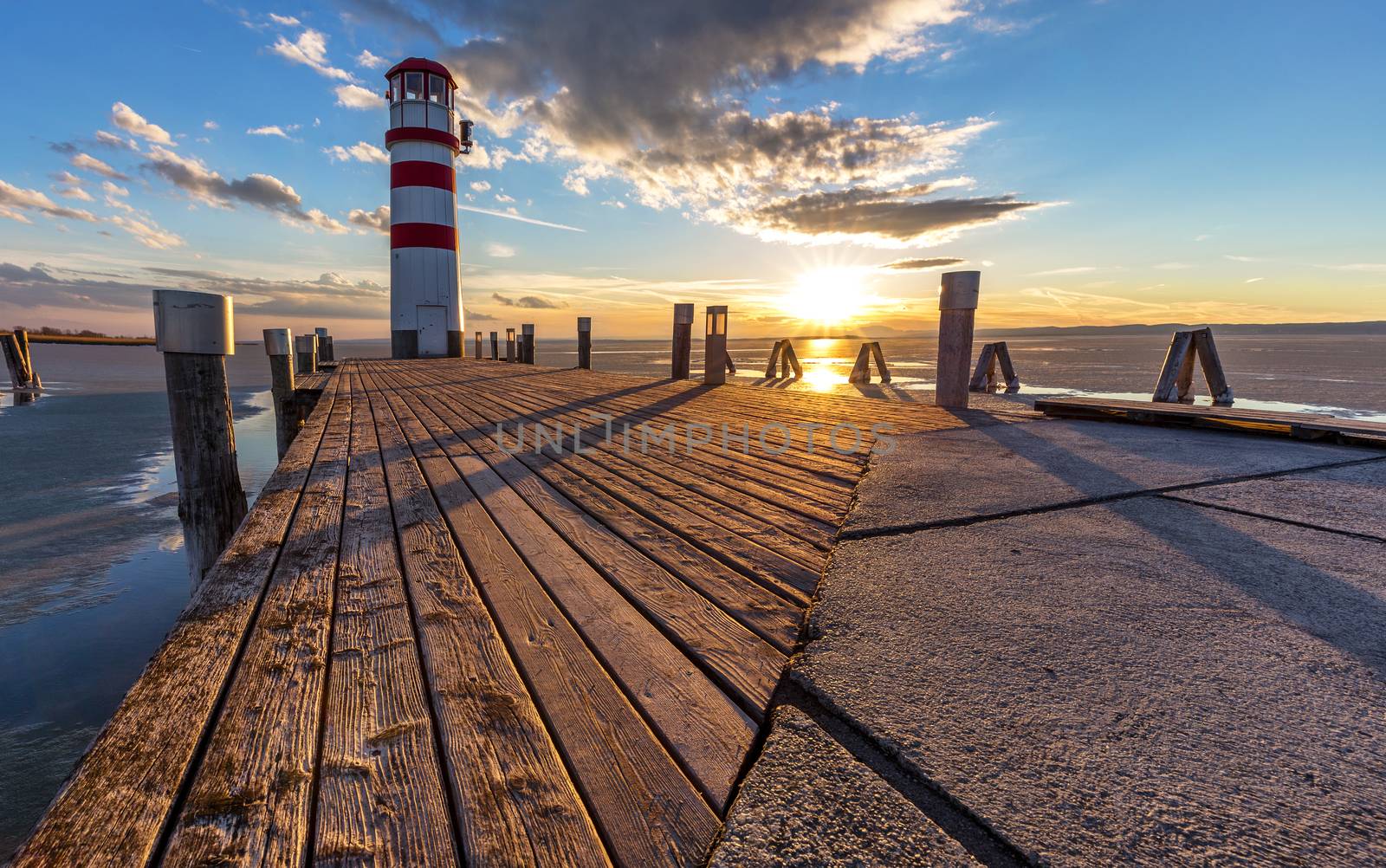 Lighthouse, dramatic sunset during winter