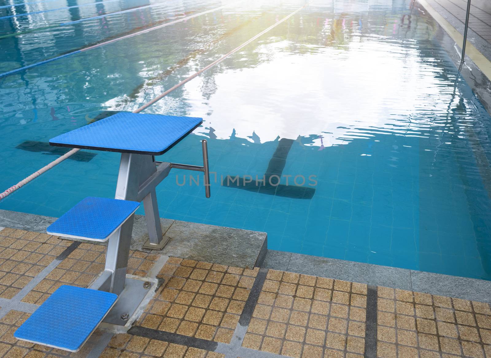 Swimming pool with marked lanes and quiet standing water. Water . With copy space for text or design