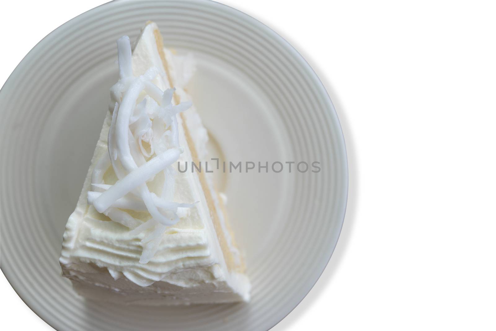 Top view close up coconut cream cake with slice Coconut on top isolate on white background. Save with cliping path.