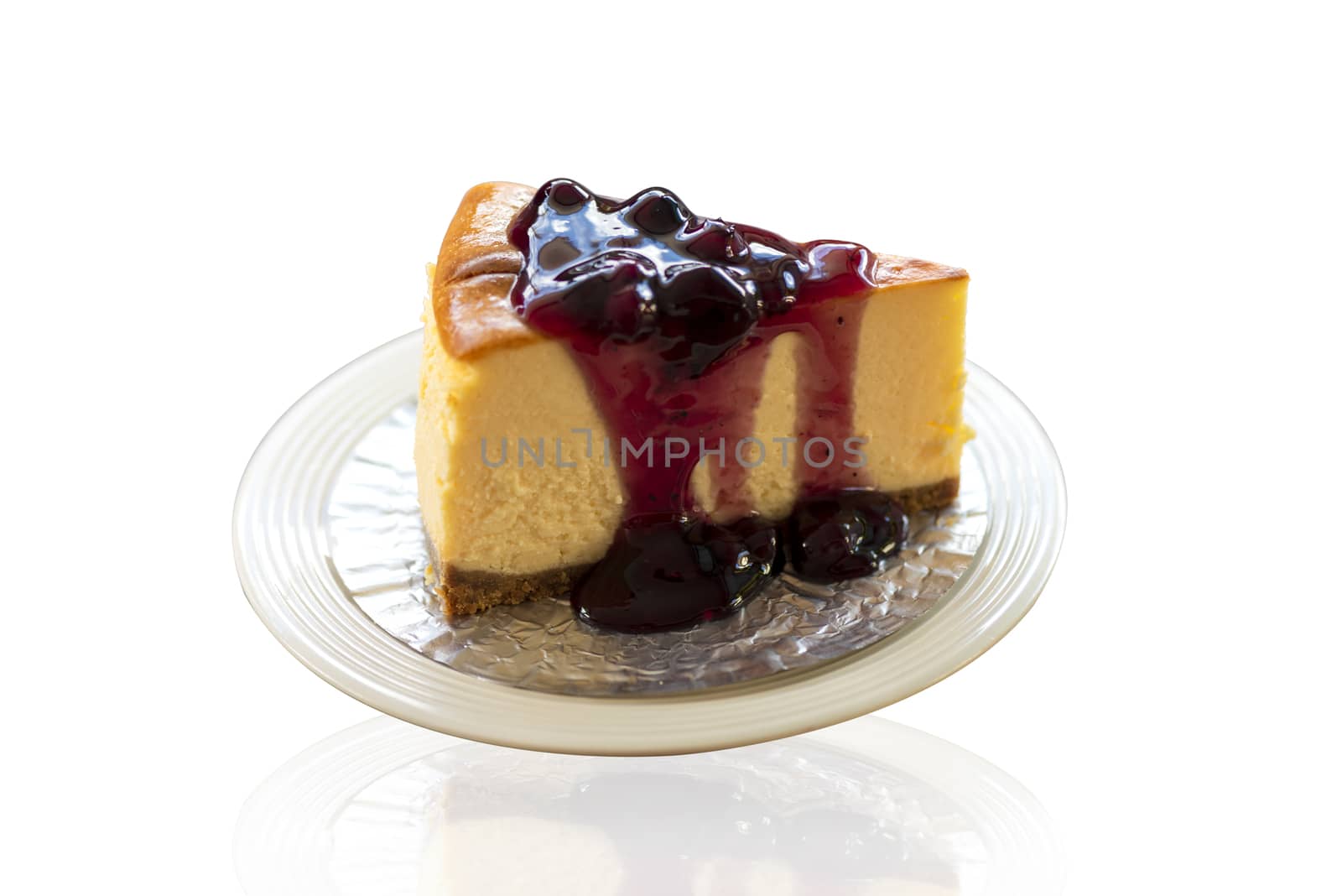 Homemade blueberry cheesecake on white plate. Isolate on white bakcground