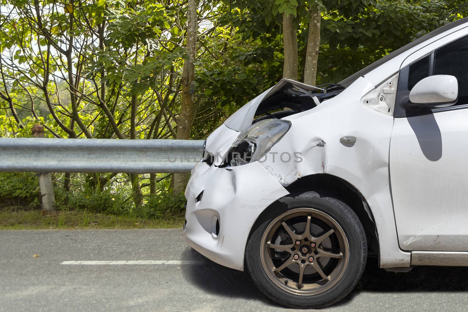 Front of white color car big damaged and broken by accident on city street parking can not drive any more. With copy space for text or designa