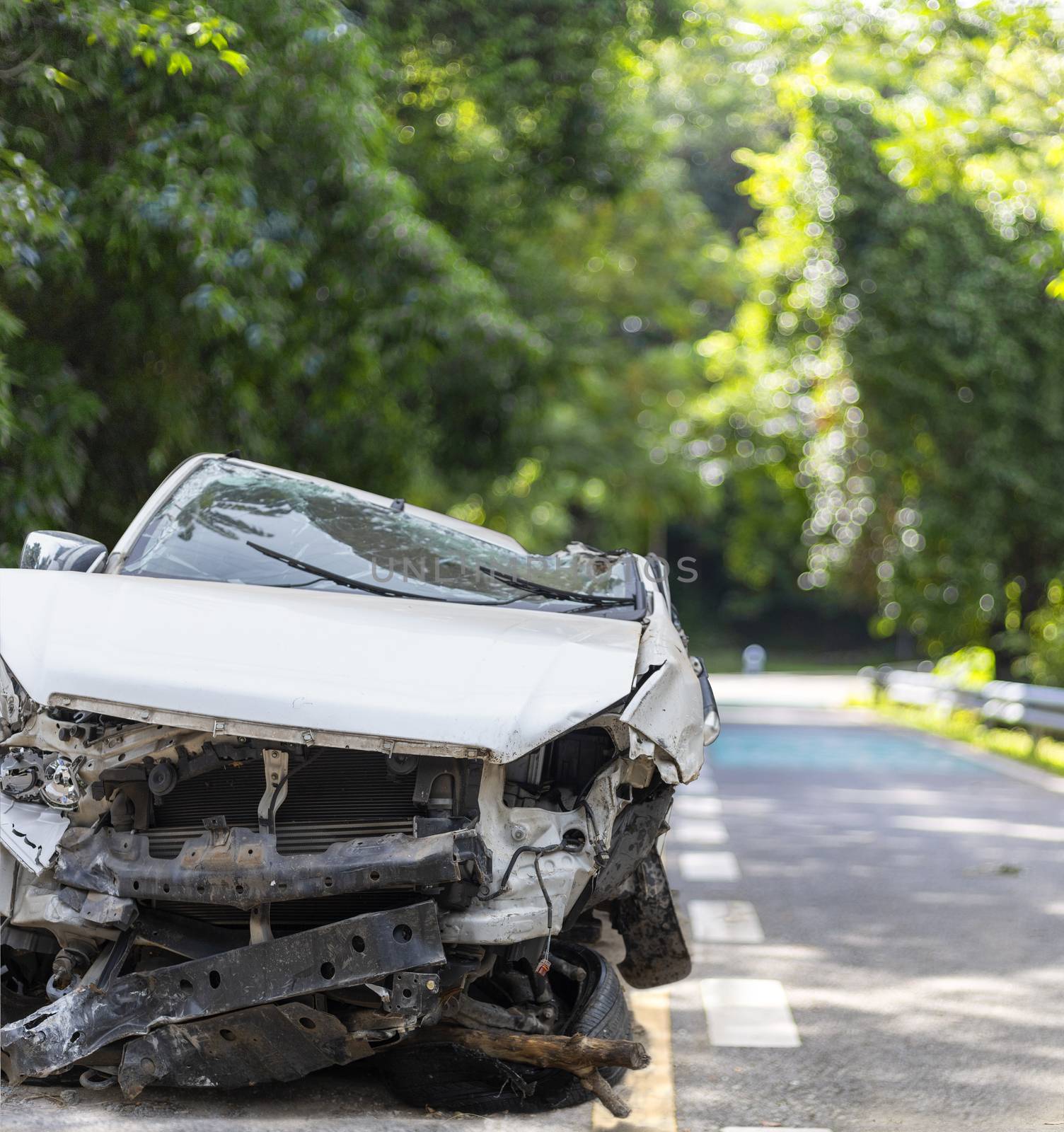 Front of white color car big damaged and broken by accident on road parking can not drive any more. With copy space for text or design