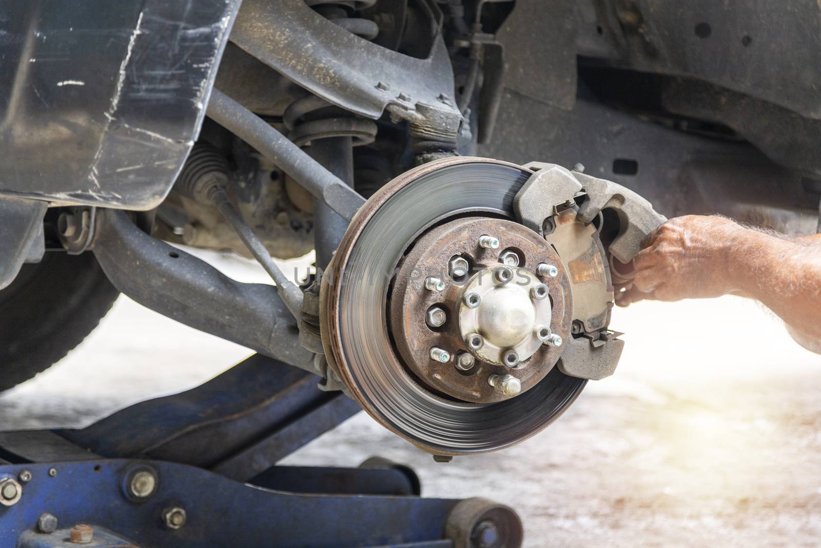 Transportation concept. Hand mechanic repair brake disc . 