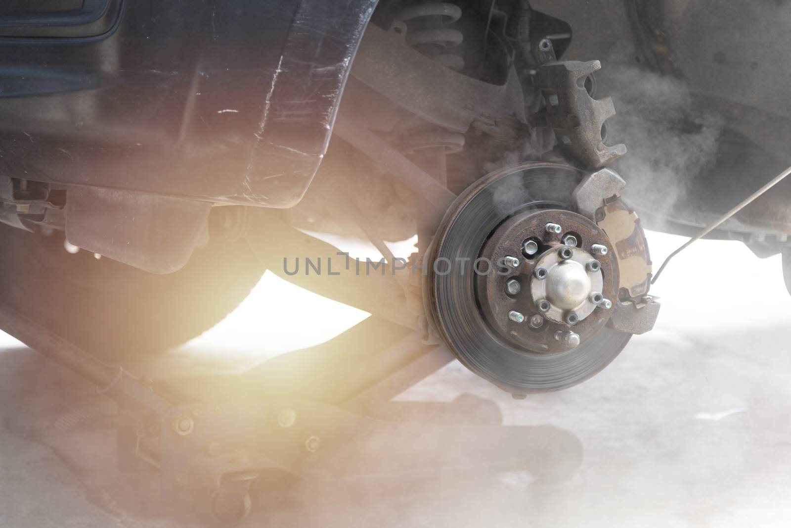 Mechanic use air gun clean disc break take dust removes before change break pat.