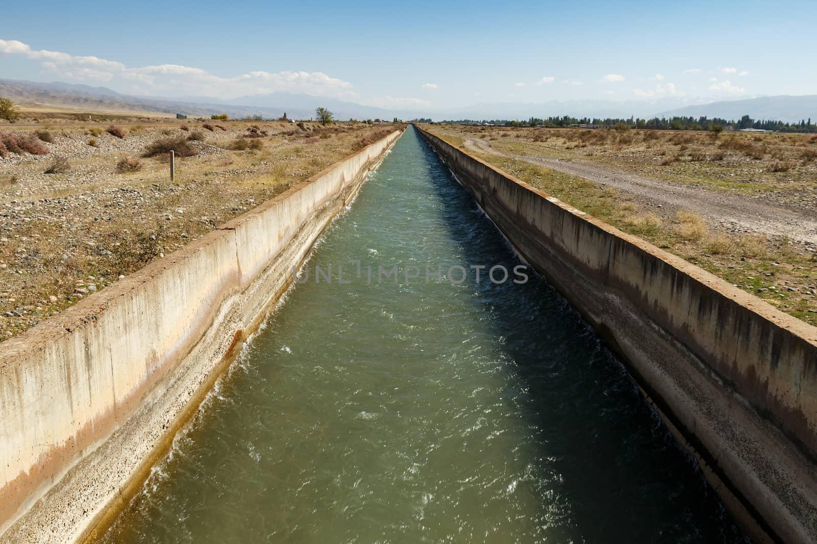 Irrigation canal Chuy Province. water flowing in an irrigation canal in Kyrgyzstan.