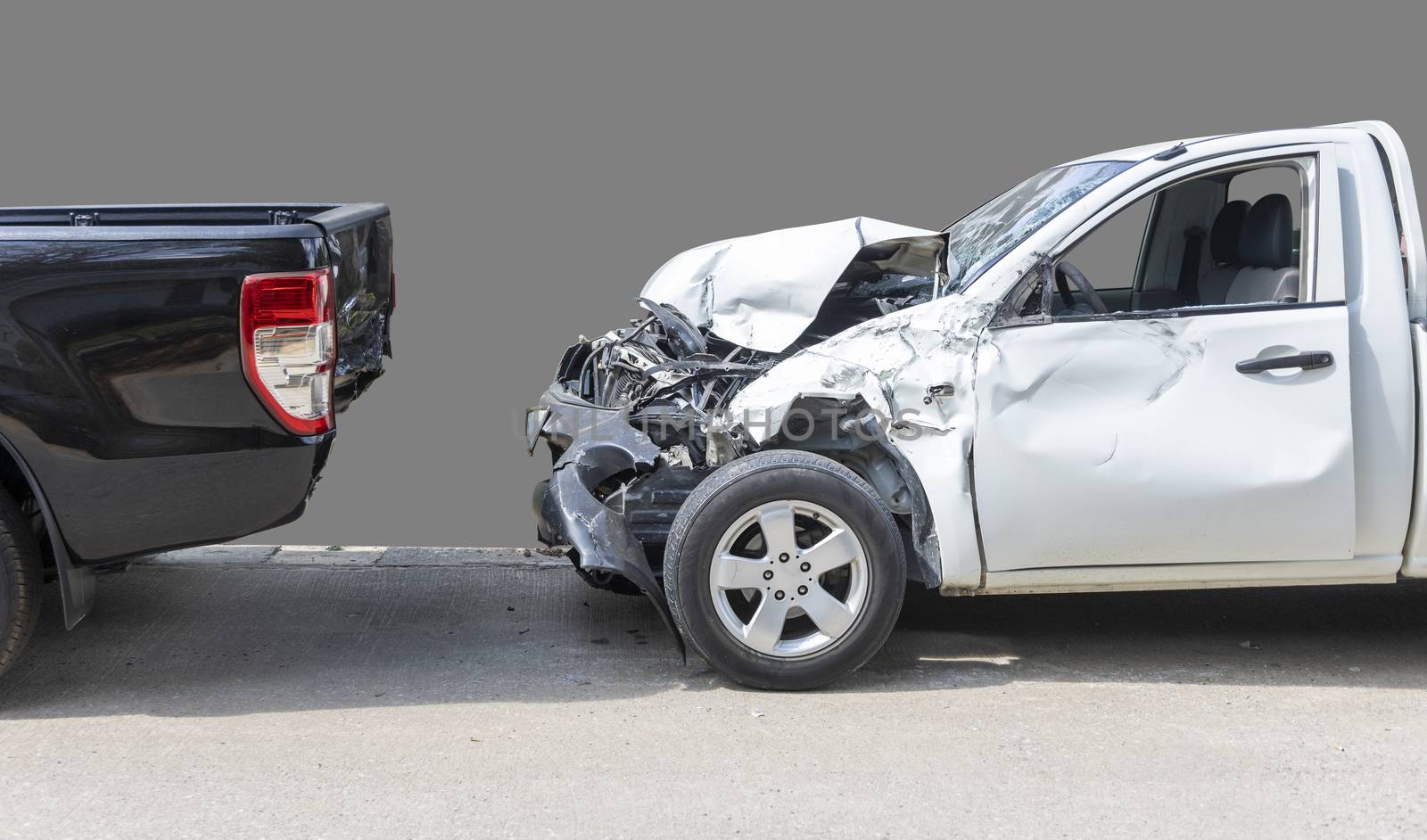 Front White color pack up car crash with back side black color car get damaged by accident on road. Save with clipping path.