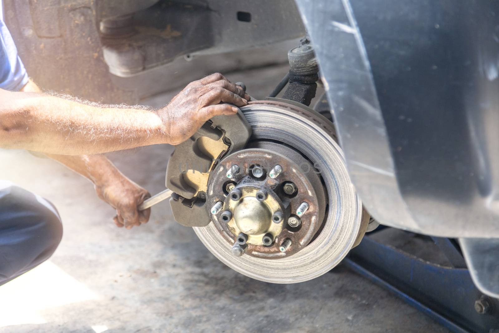 Transportation concept. Hand mechanic repair brake disc . 