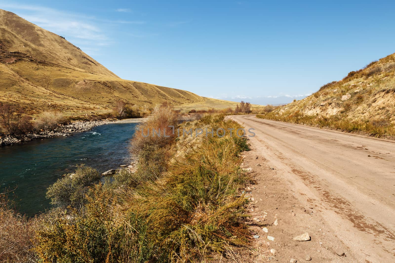 mountain road along the fast river, Kokemeren river, Jumgal District in Naryn region of Kyrgyzstan